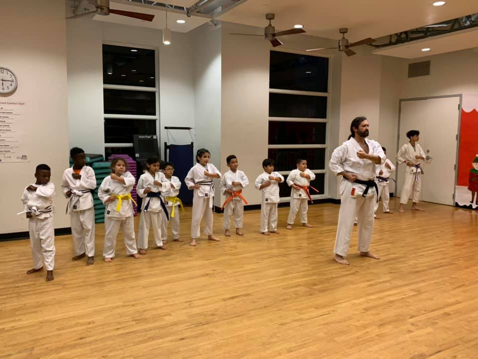 a group of children in karate uniforms