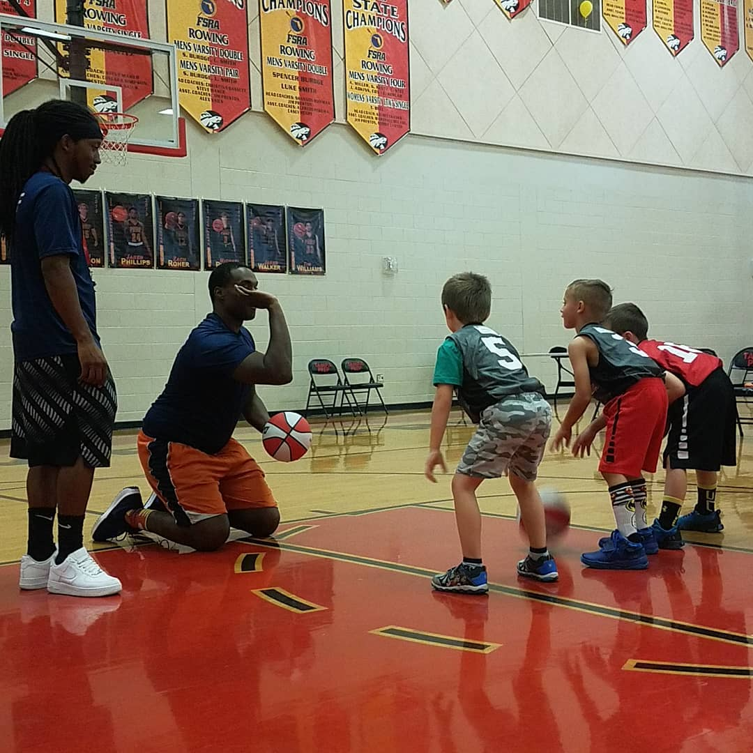 a group of kids playing basketball