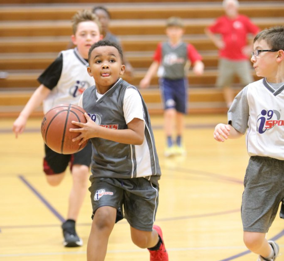 a group of kids playing basketball