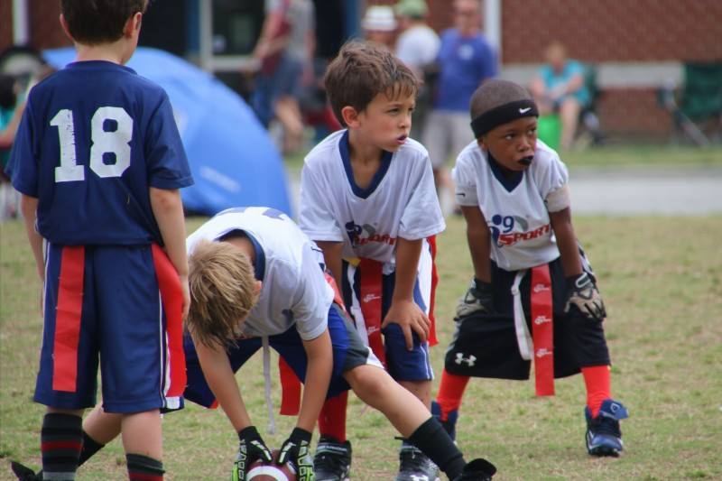 a group of kids playing football