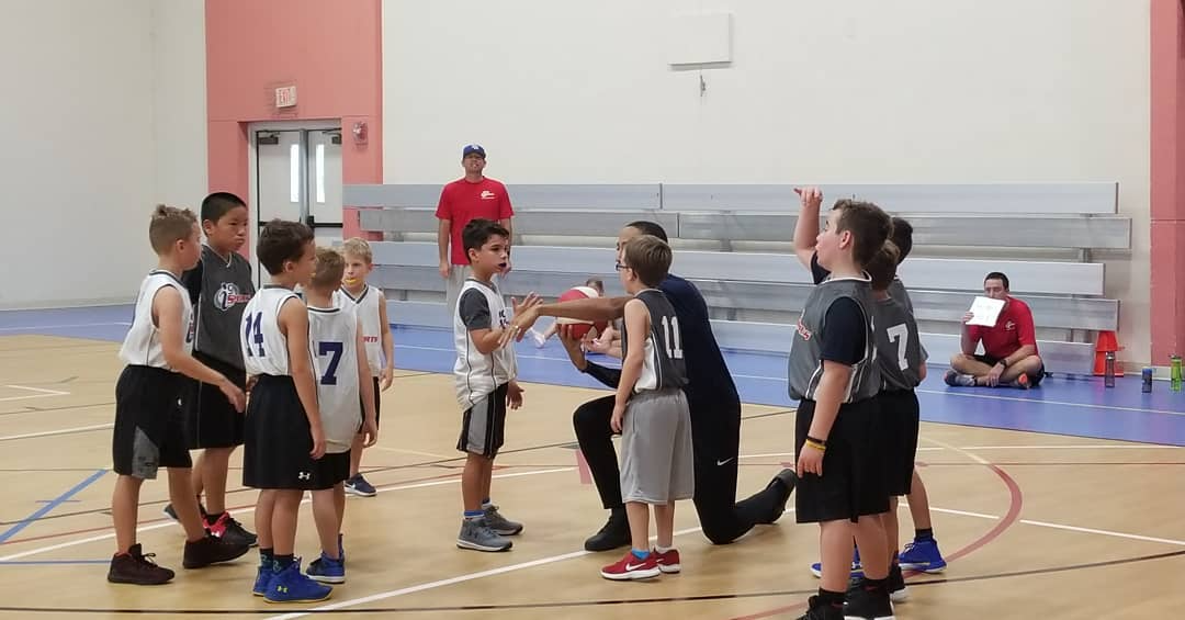 a group of kids in a gym