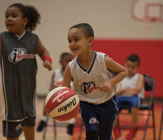 a group of kids playing basketball
