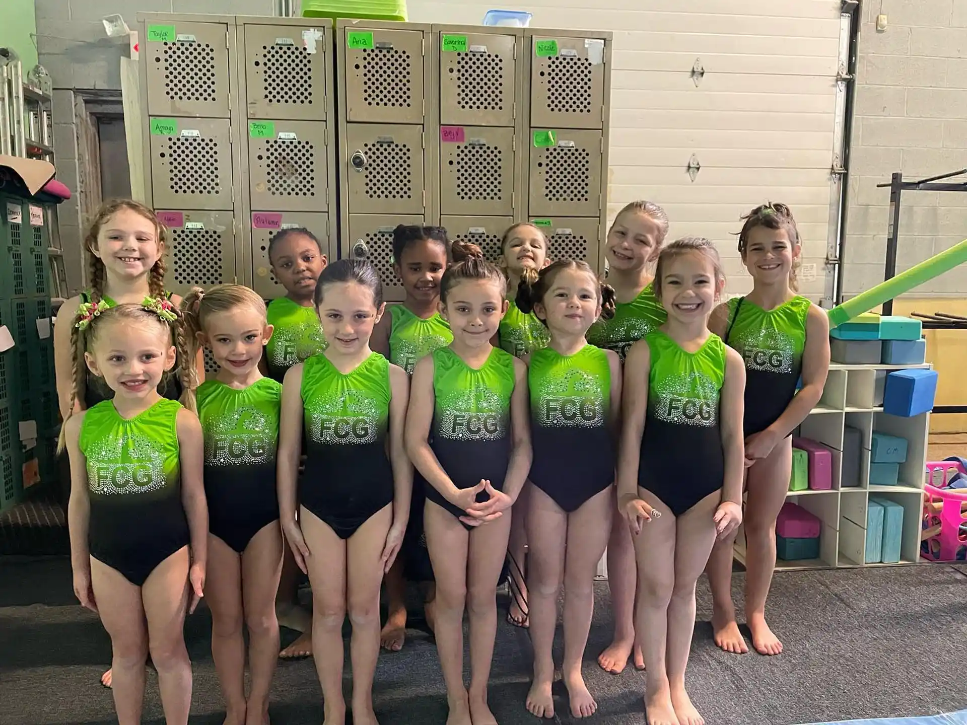 a group of girls in green and yellow swimsuits