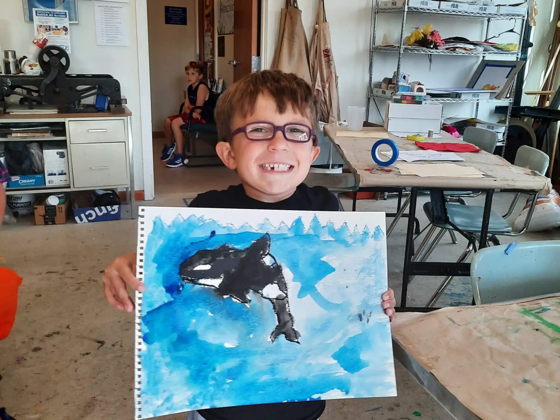 a boy holding a drawing