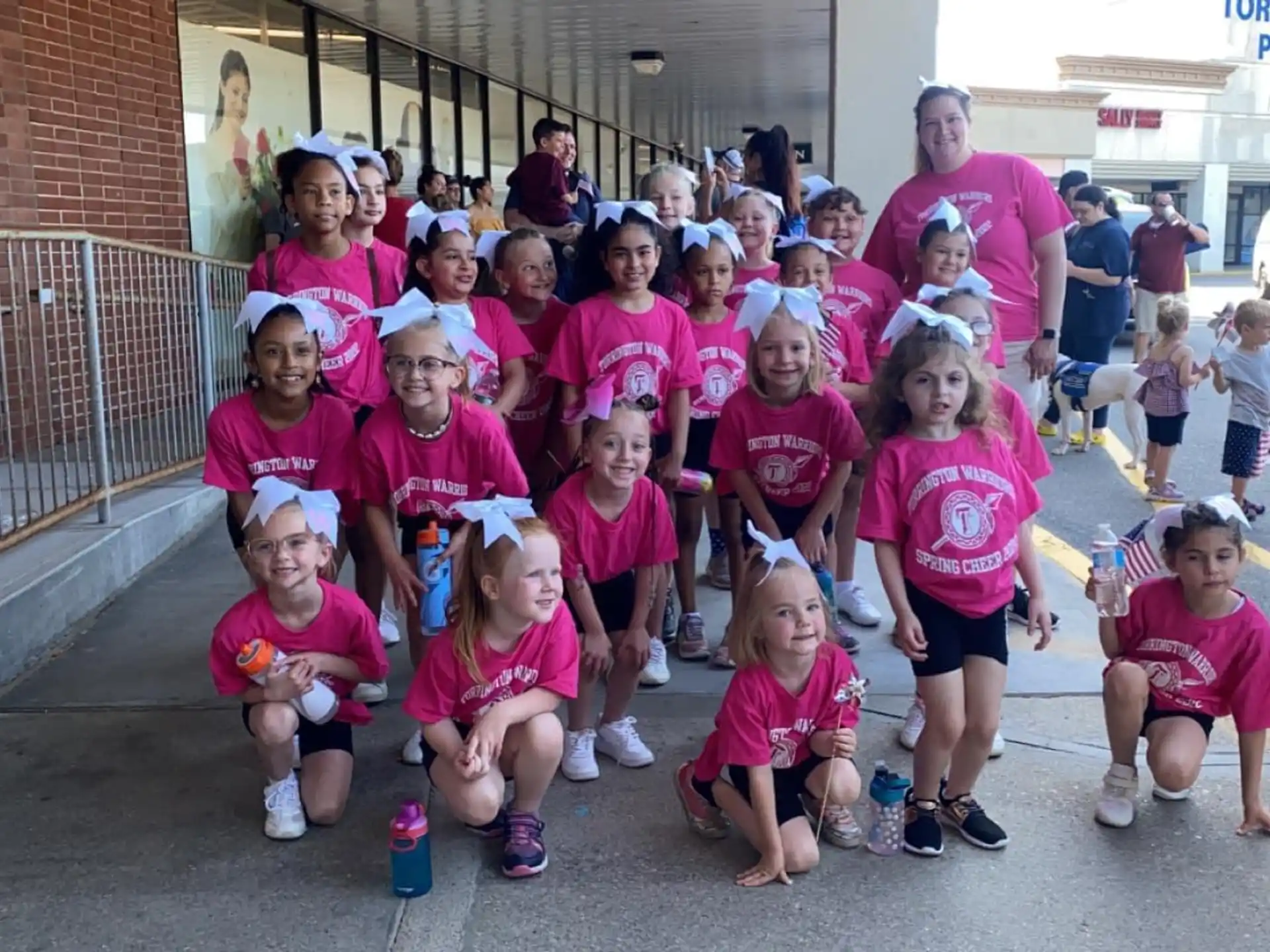 a group of people wearing matching t-shirts posing for a photo