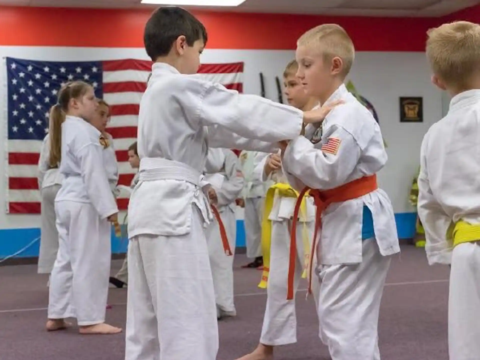 a group of children in karate uniforms