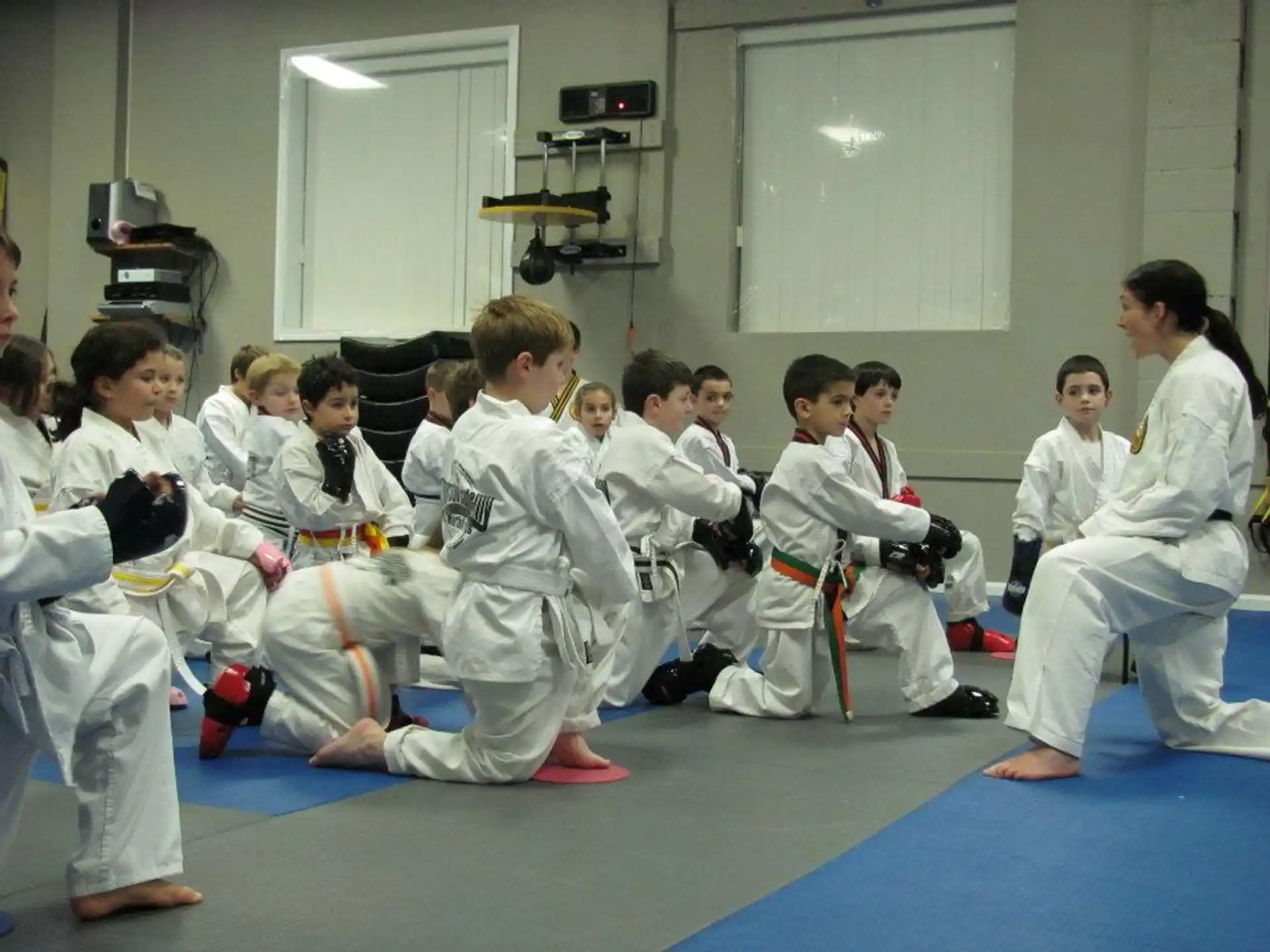 a group of people in white karate uniforms