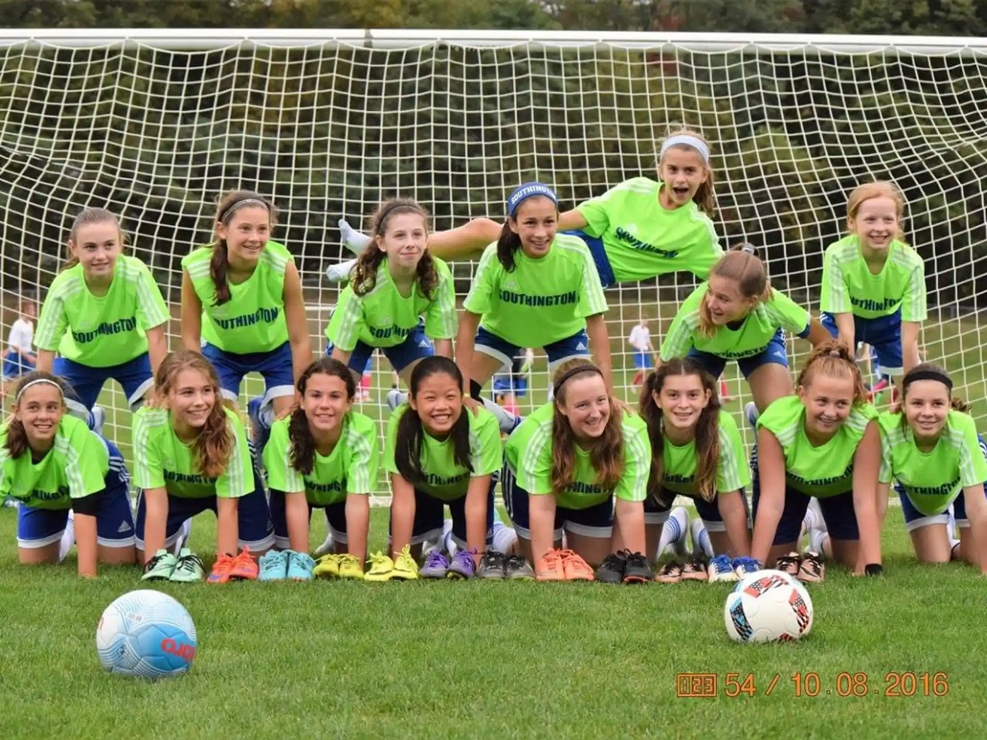a group of girls in green shirts