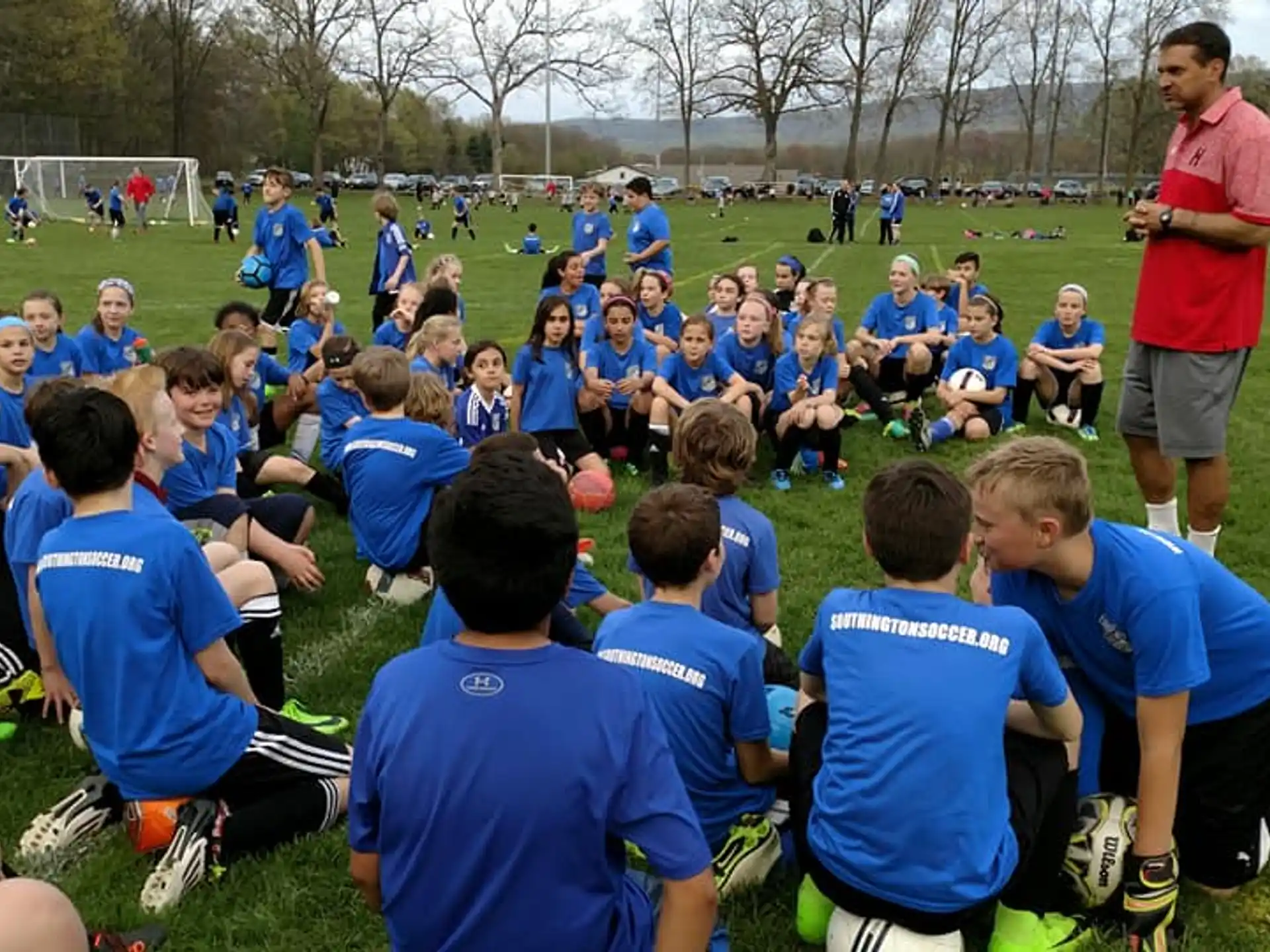 a group of people sitting on the grass