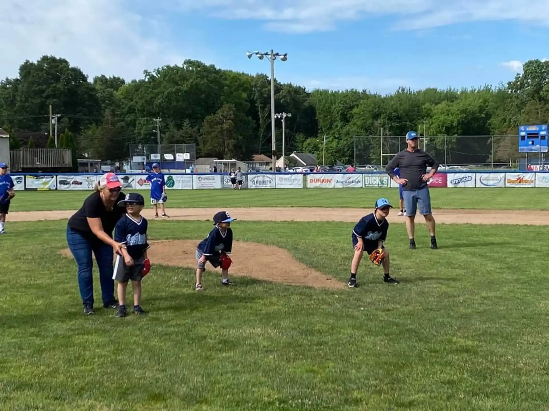 a group of kids playing baseball