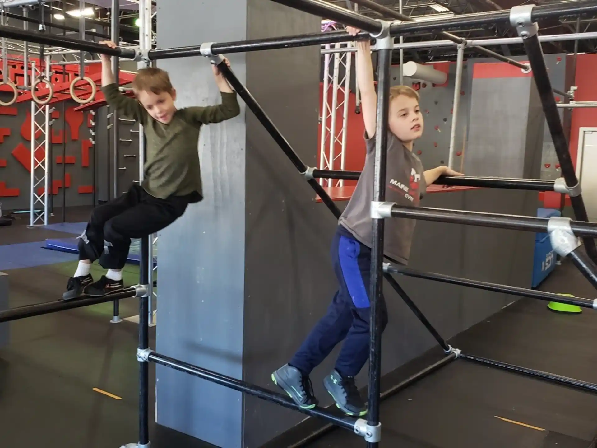 a couple of boys working out in a gym