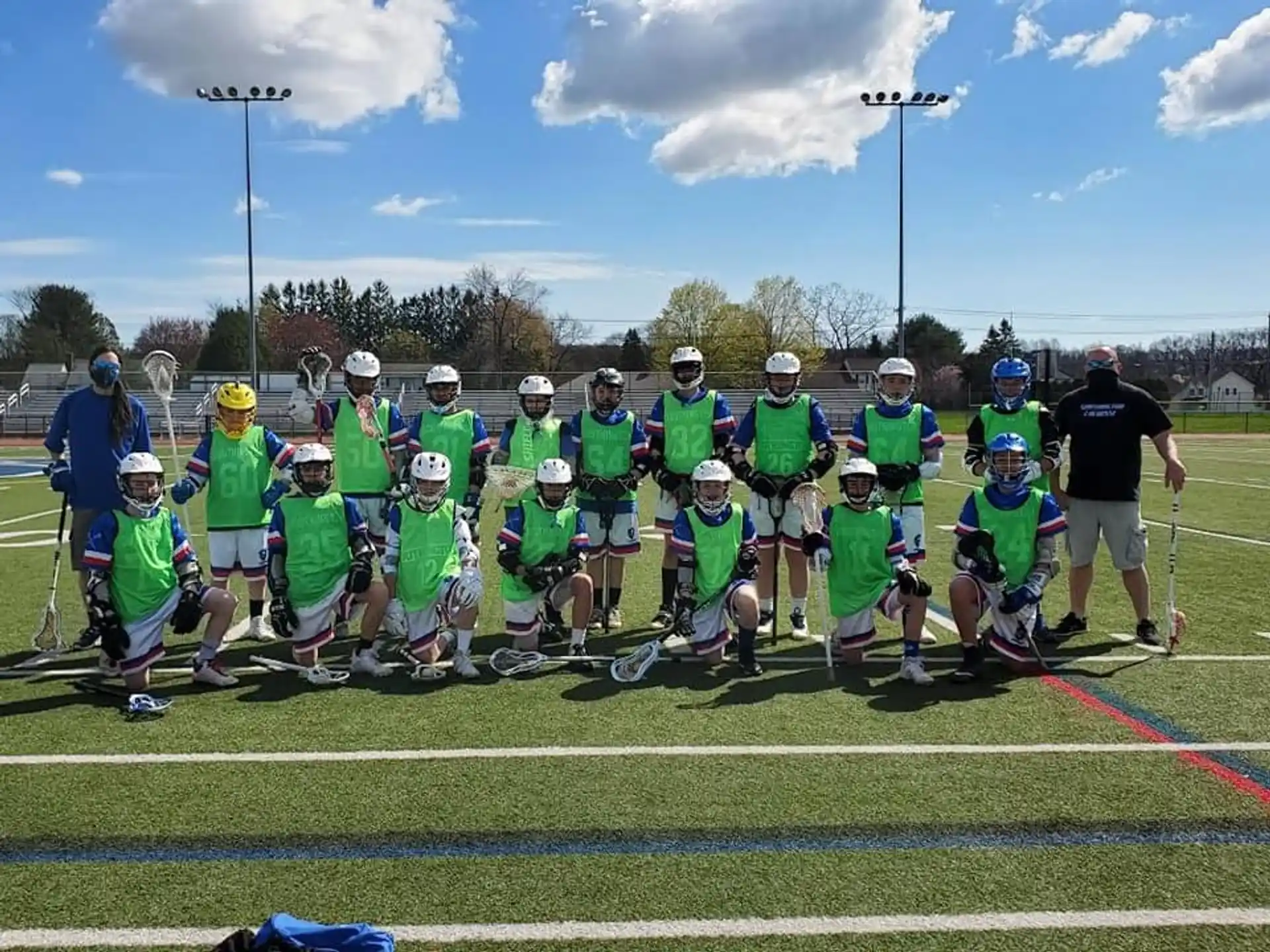 a group of people wearing helmets and standing on a field