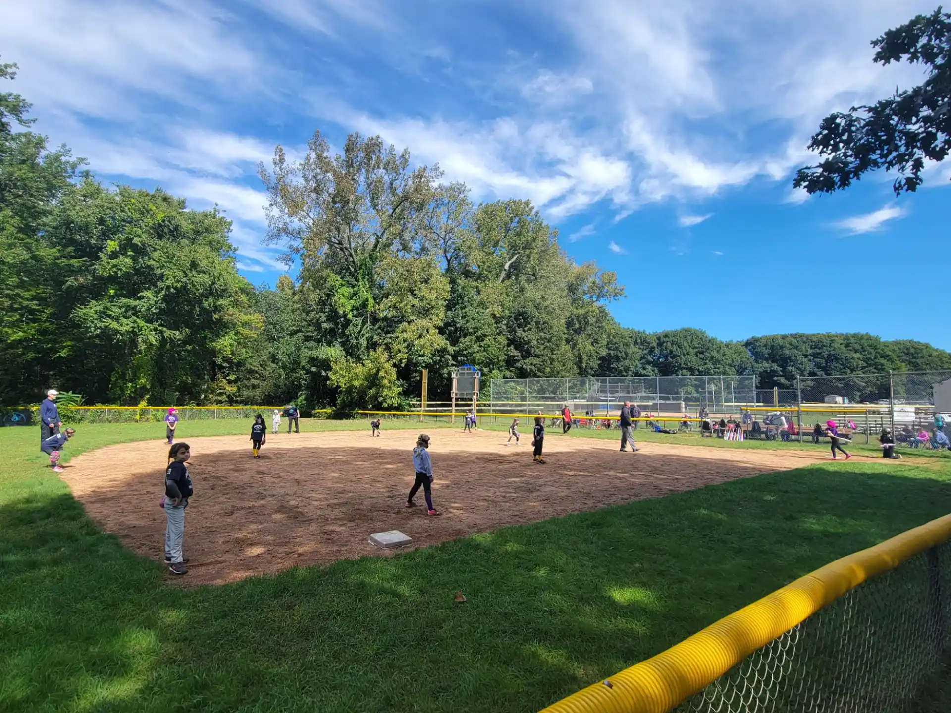 a group of people playing baseball