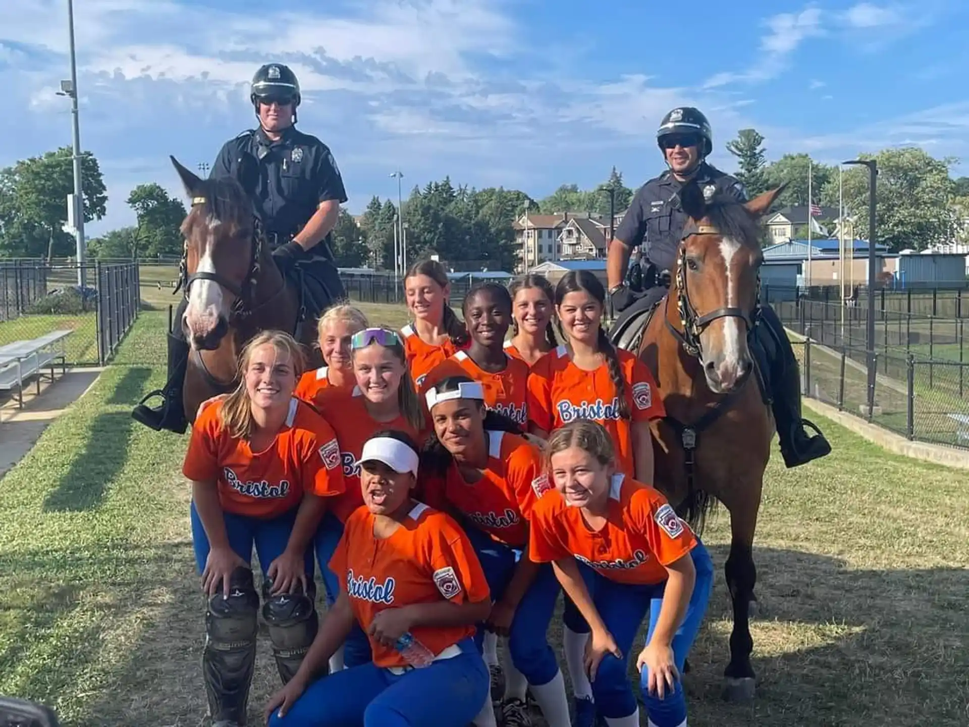 a group of people posing for a photo with a horse and a man on a horse
