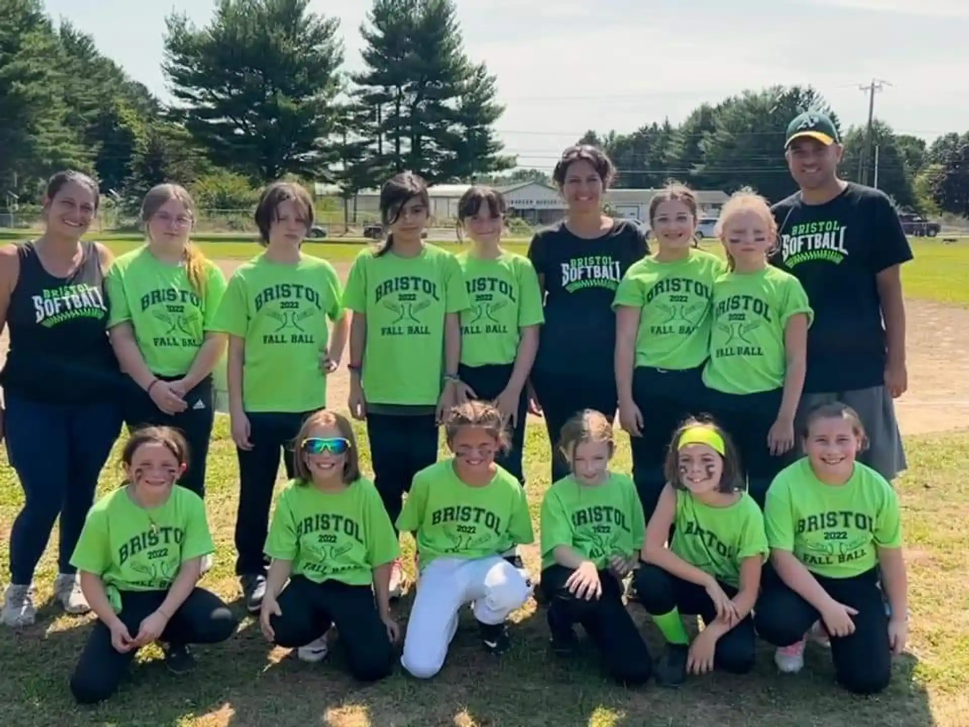a group of people wearing green shirts