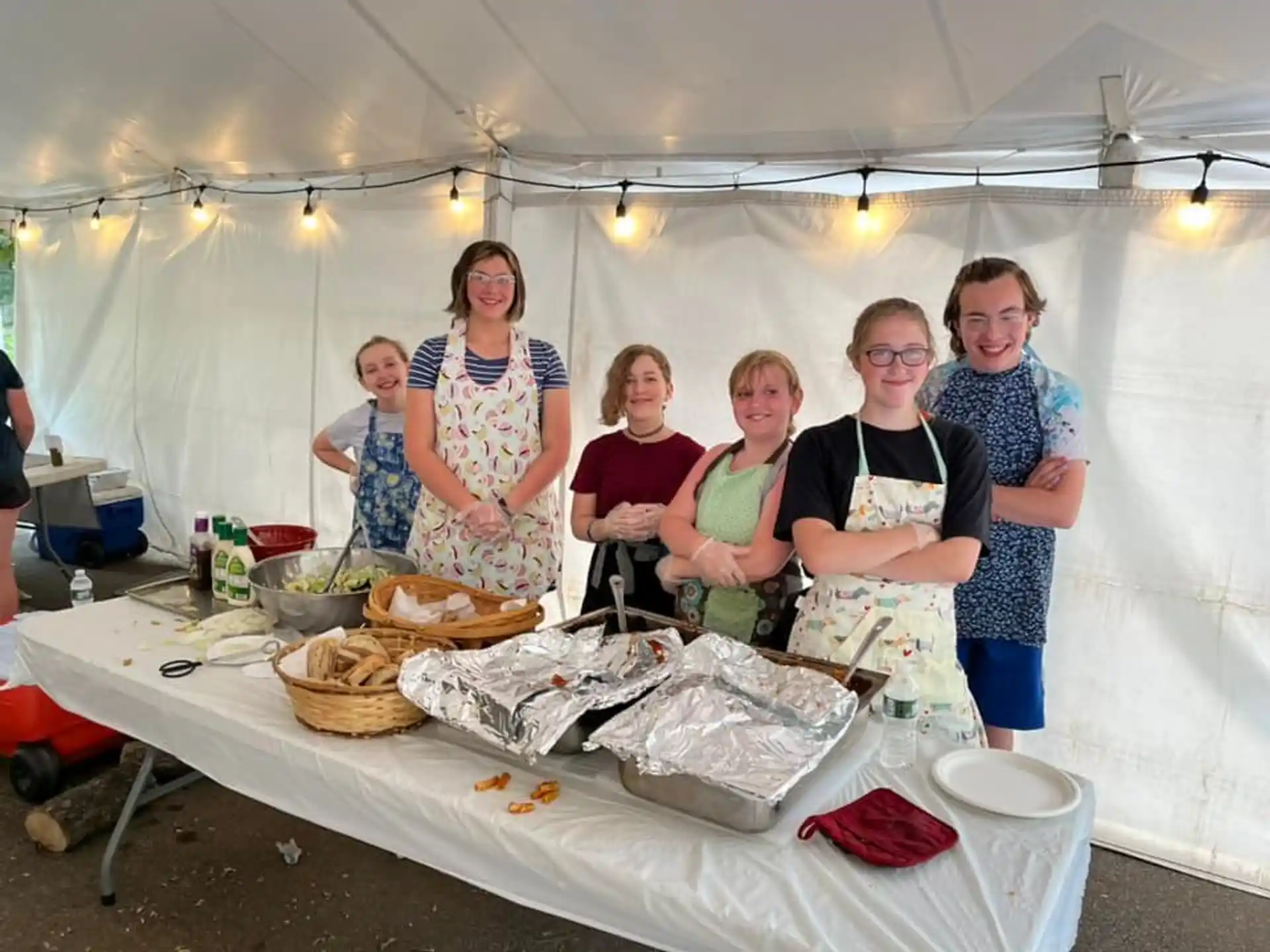 a group of women standing in a tent