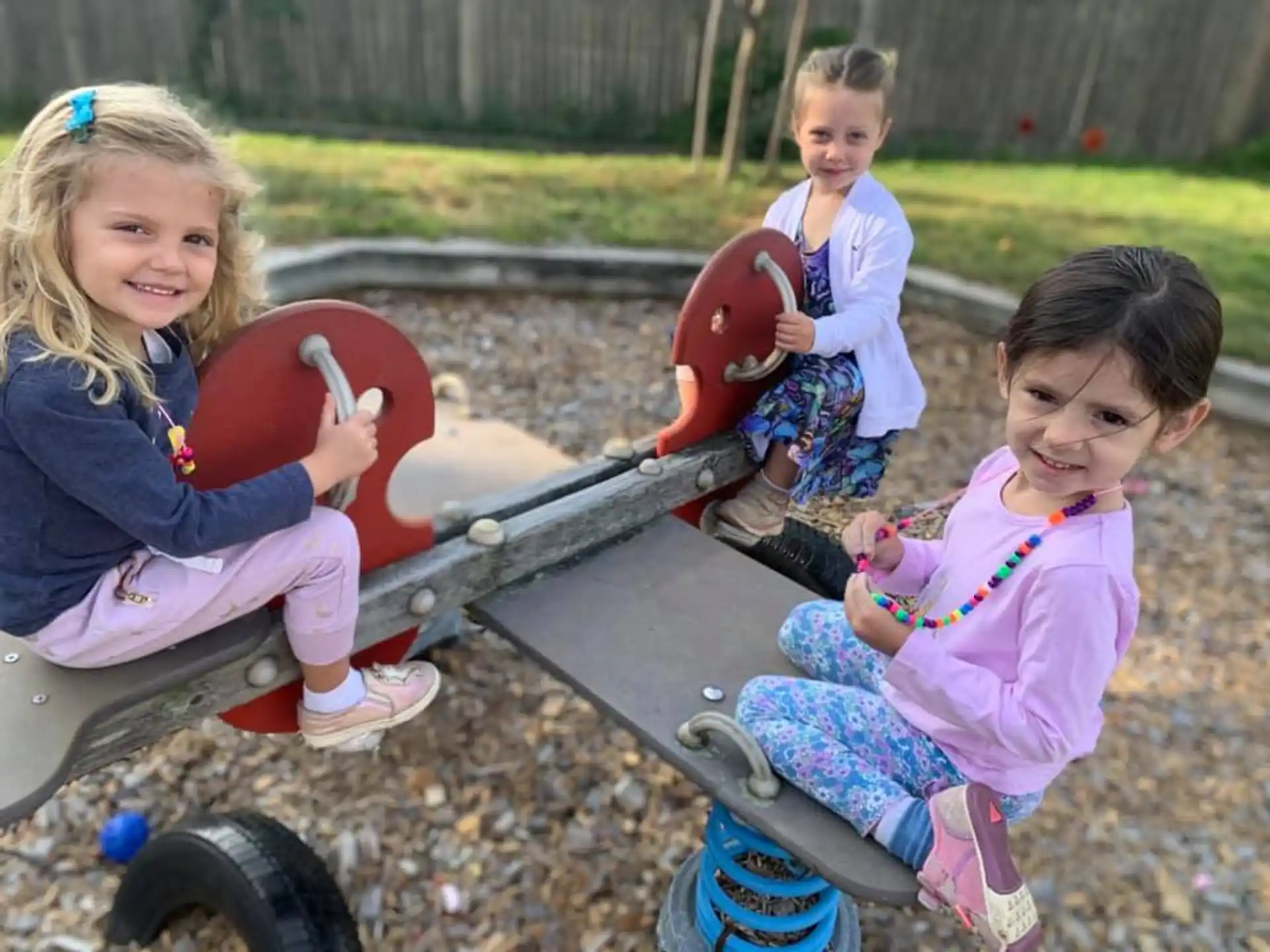 a group of children sitting on a toy train