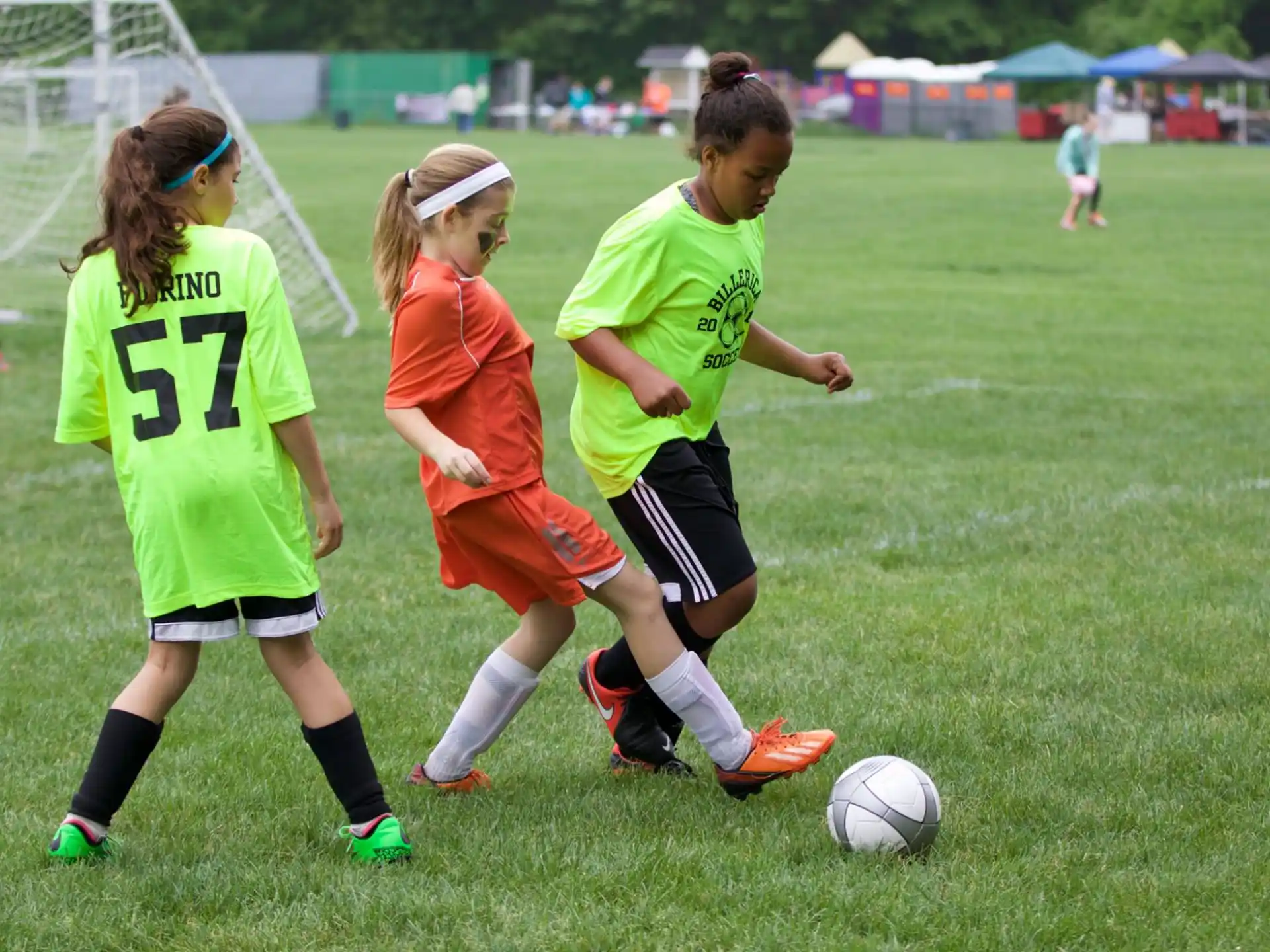 girls playing football on a field