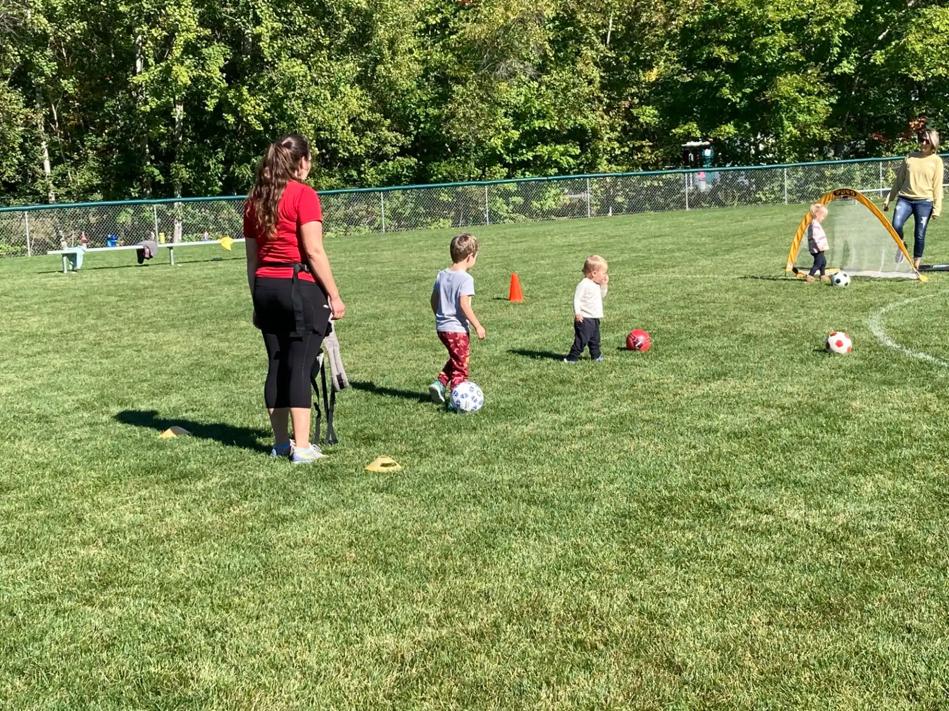 a person and kids playing football