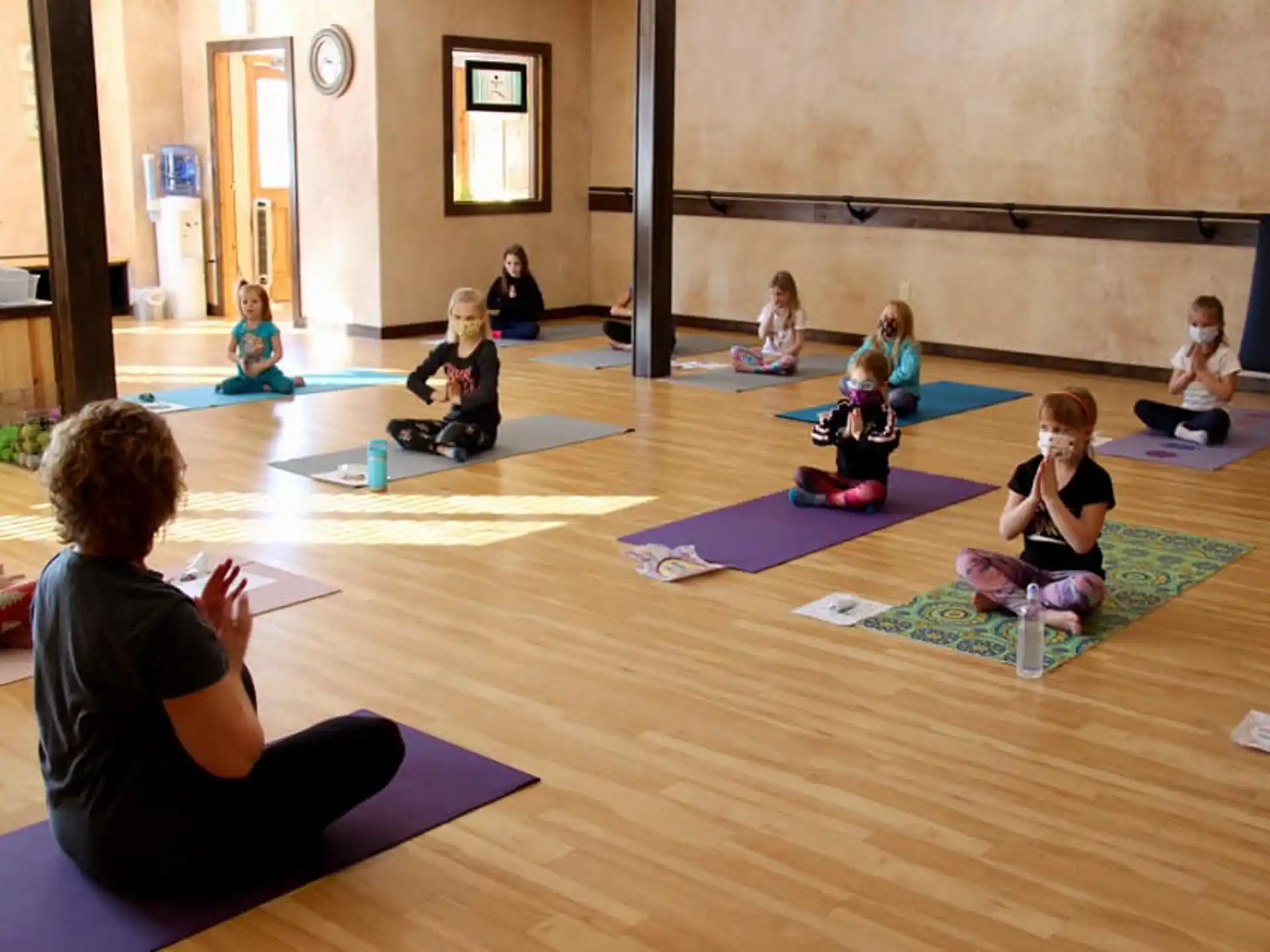 a group of children sitting on mats