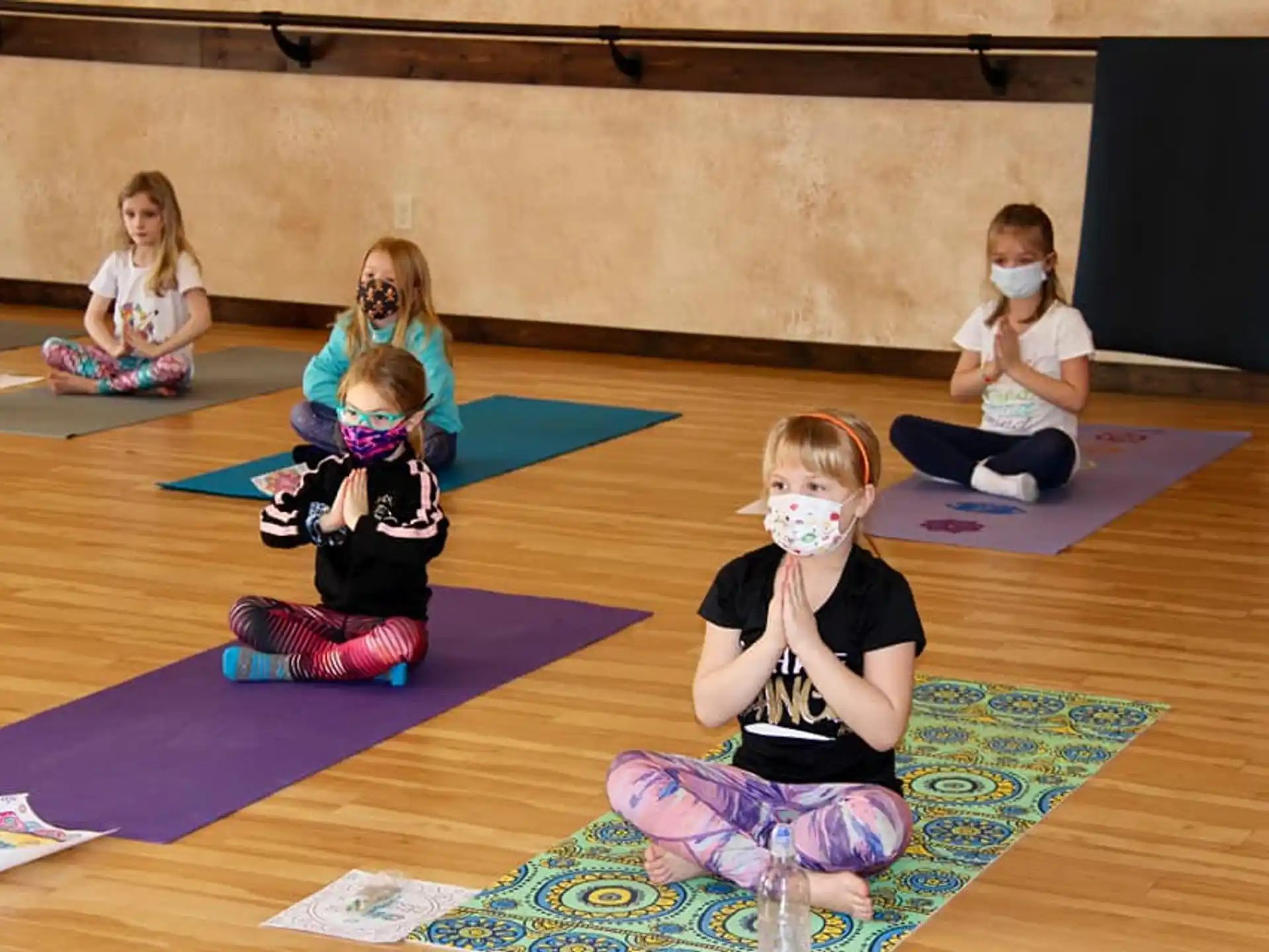 a group of children sitting on mats