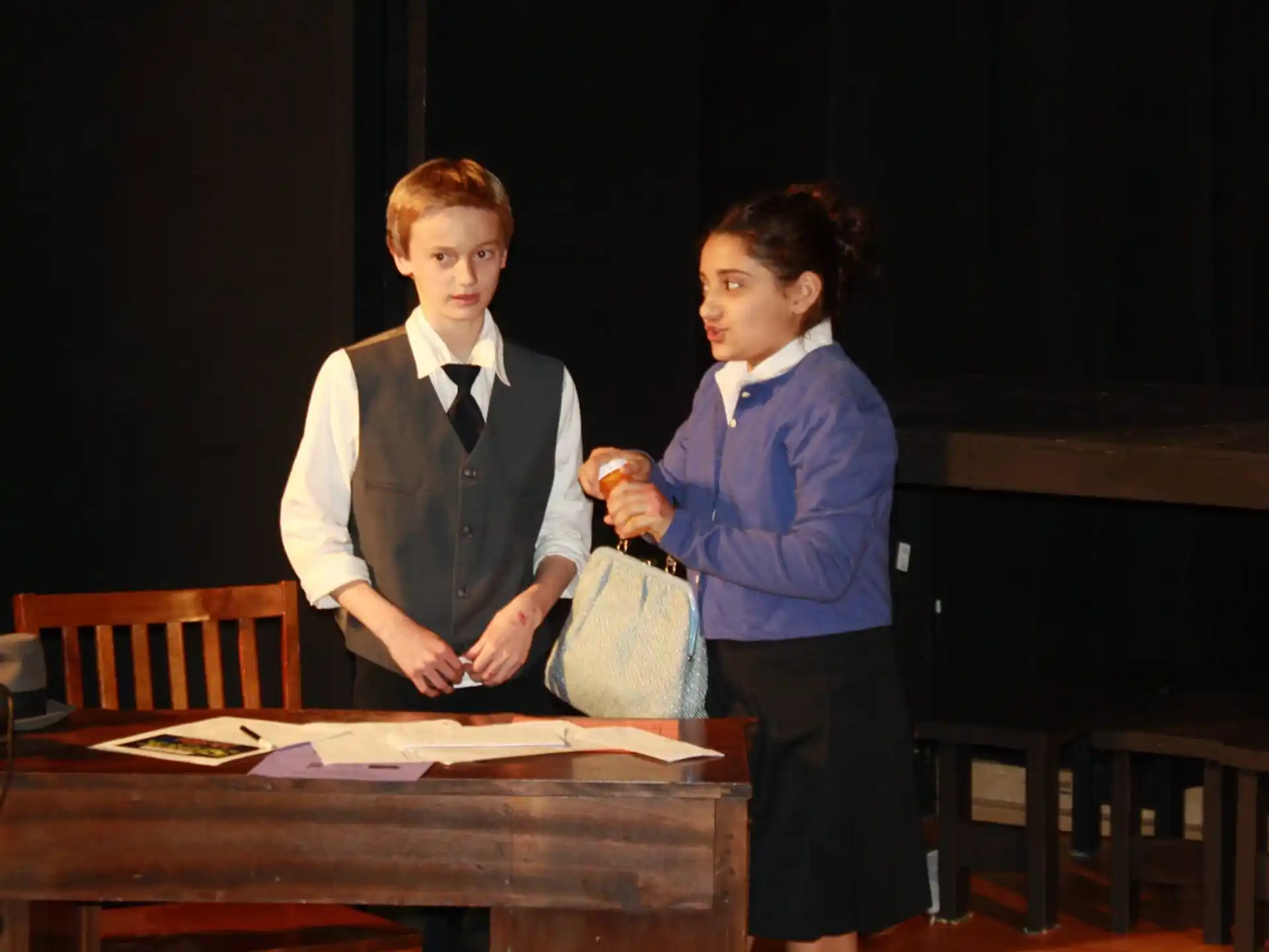 a boy and girl standing next to each other in a room