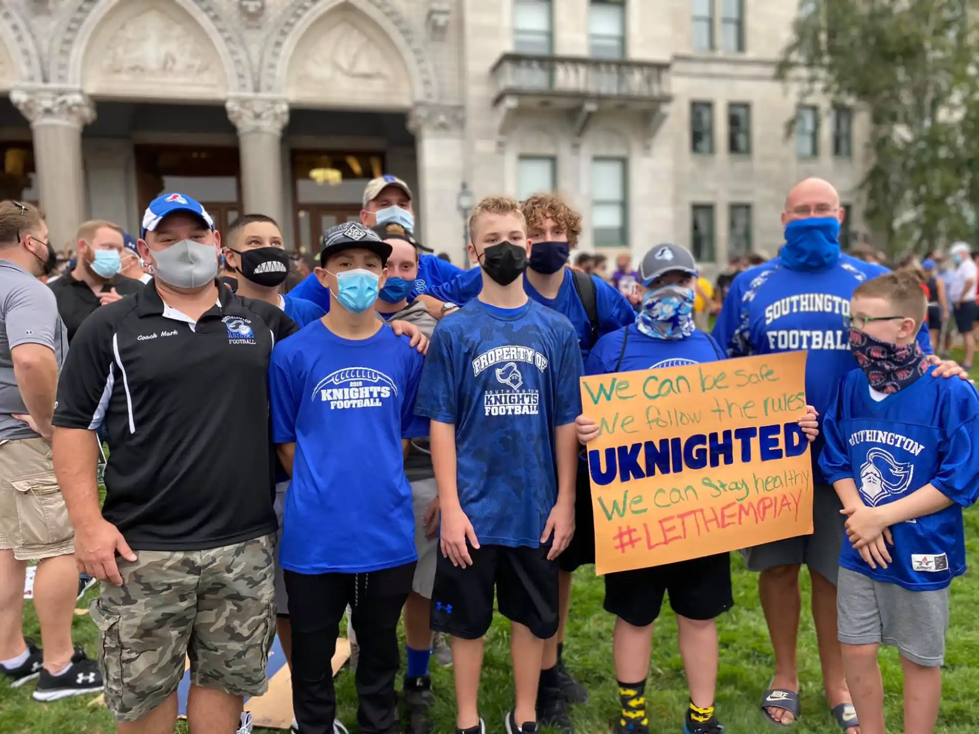 a group of people holding a sign