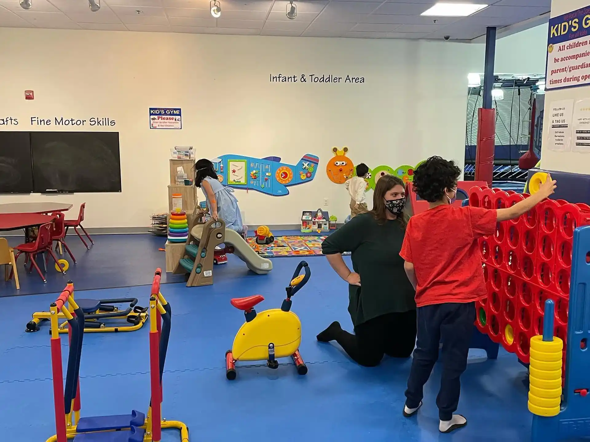 a group of people playing on a trampoline in a gym