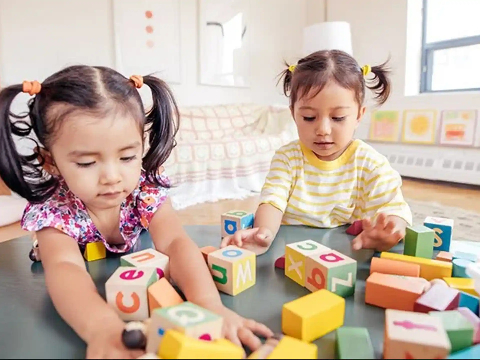 a couple of children playing with blocks