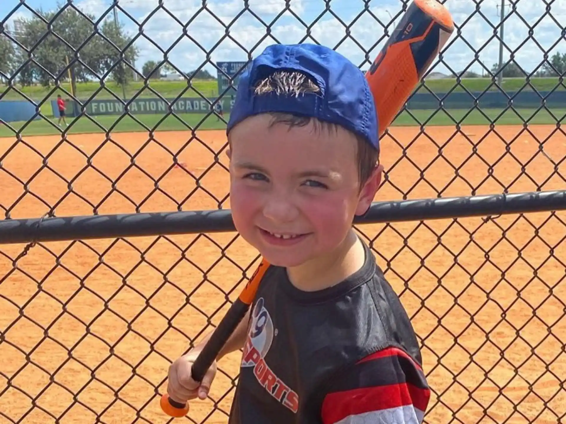 a boy holding a baseball bat