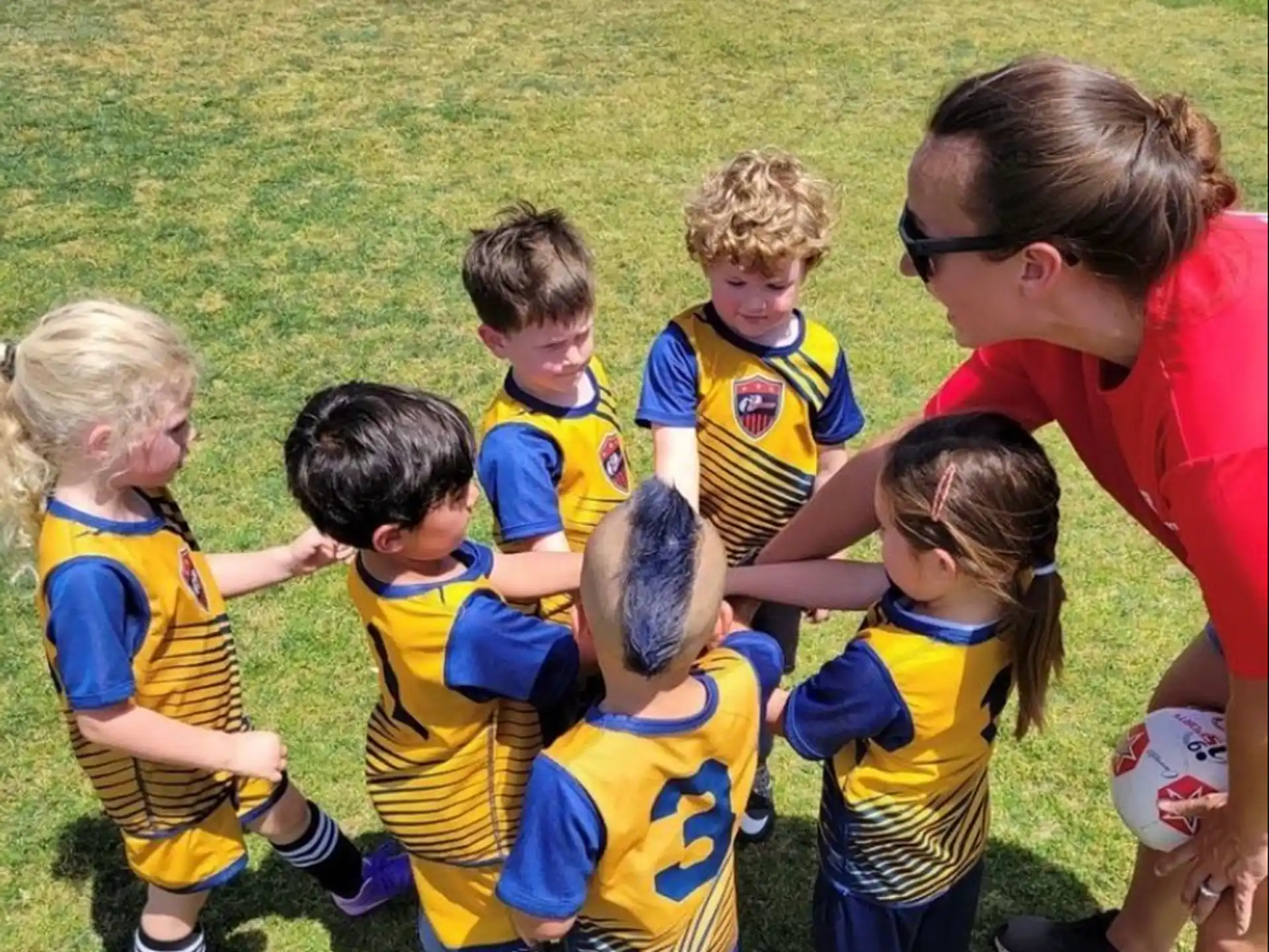 a group of kids in football uniforms