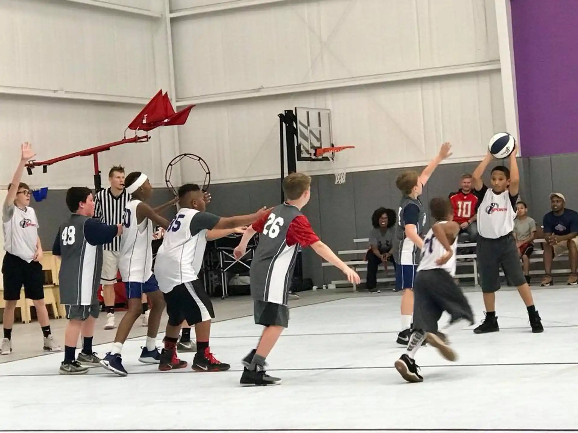 a group of people playing basketball