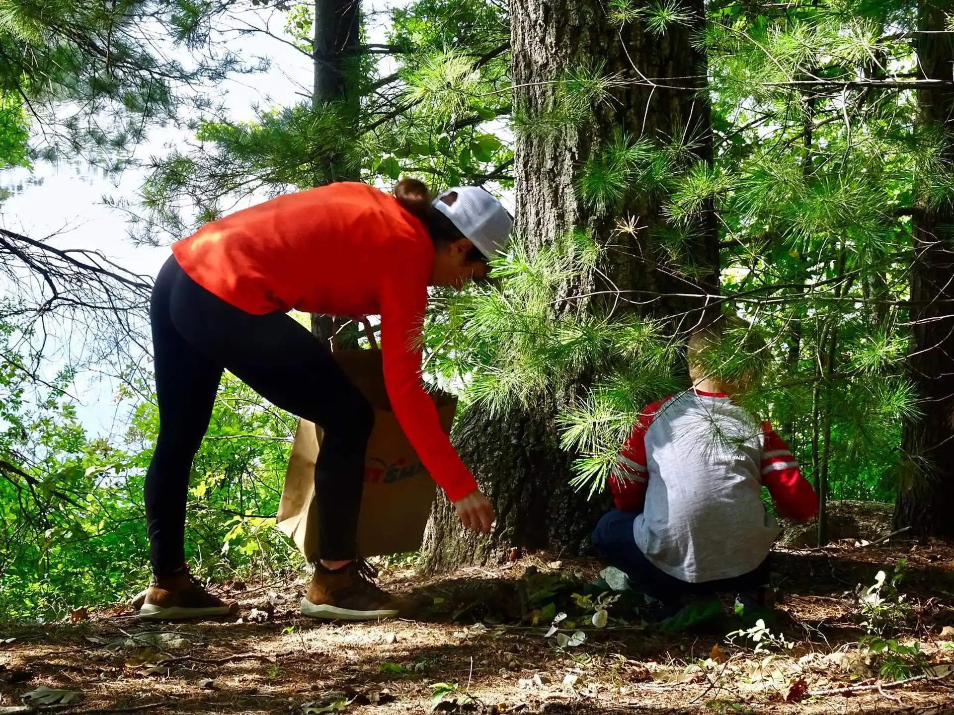 a person helping another man in the forest