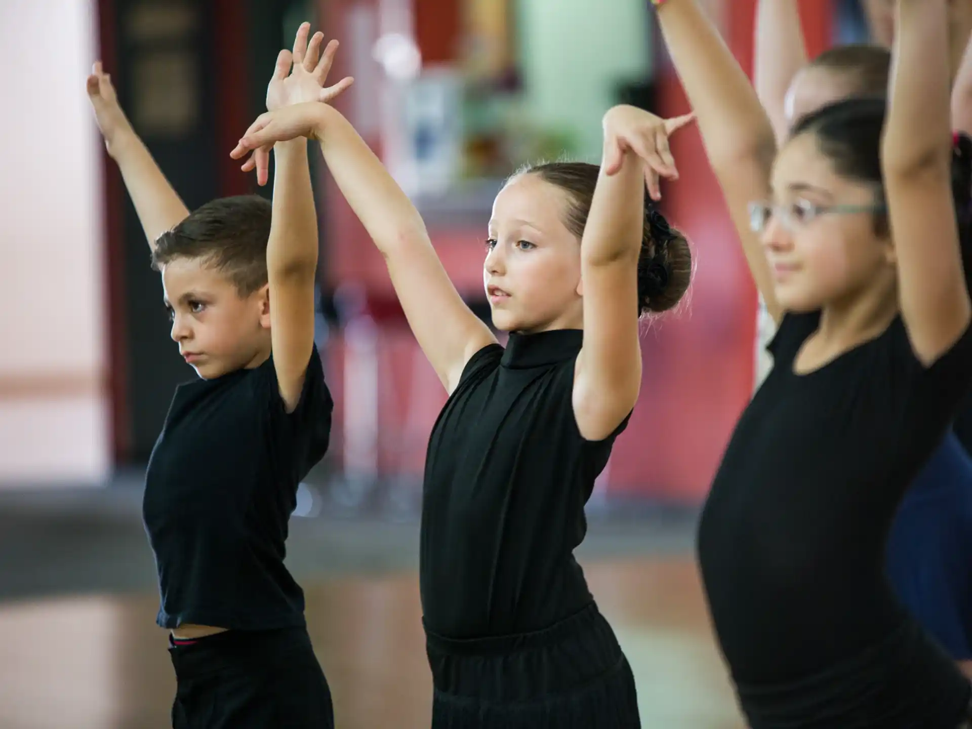 a group of children raising their hands