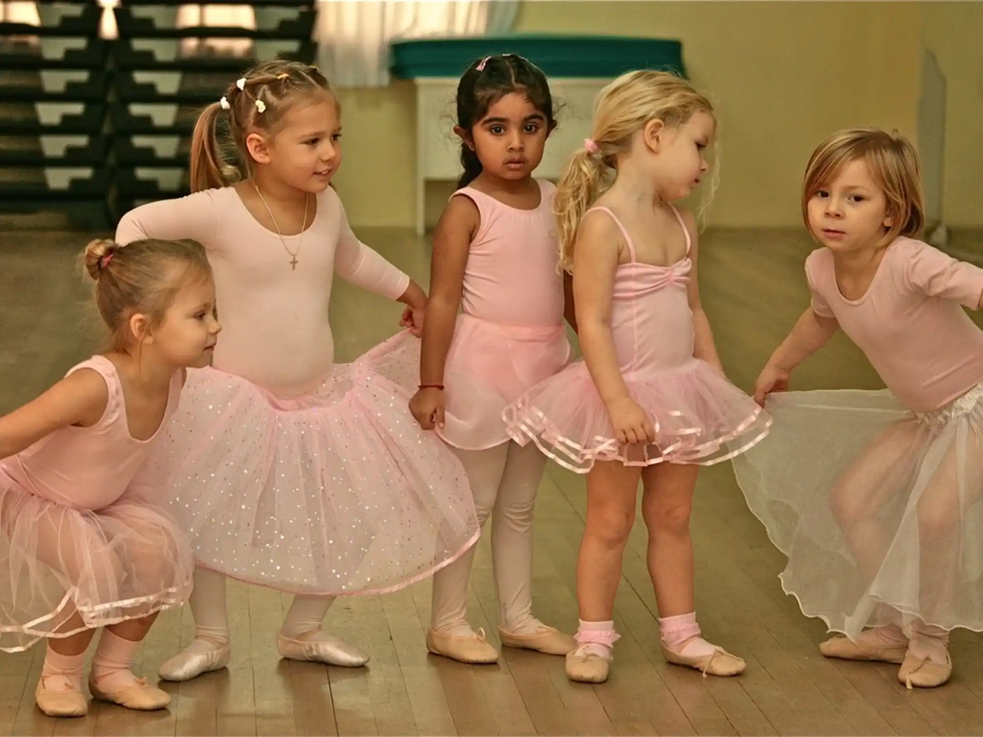 a group of girls in dresses