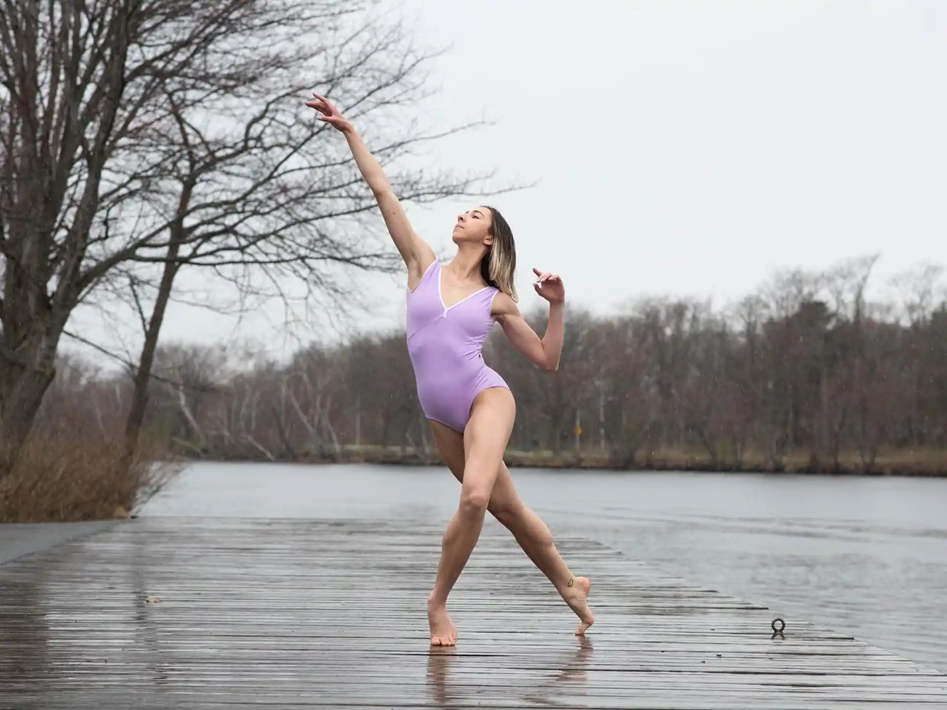 a woman in a dress jumping in the water