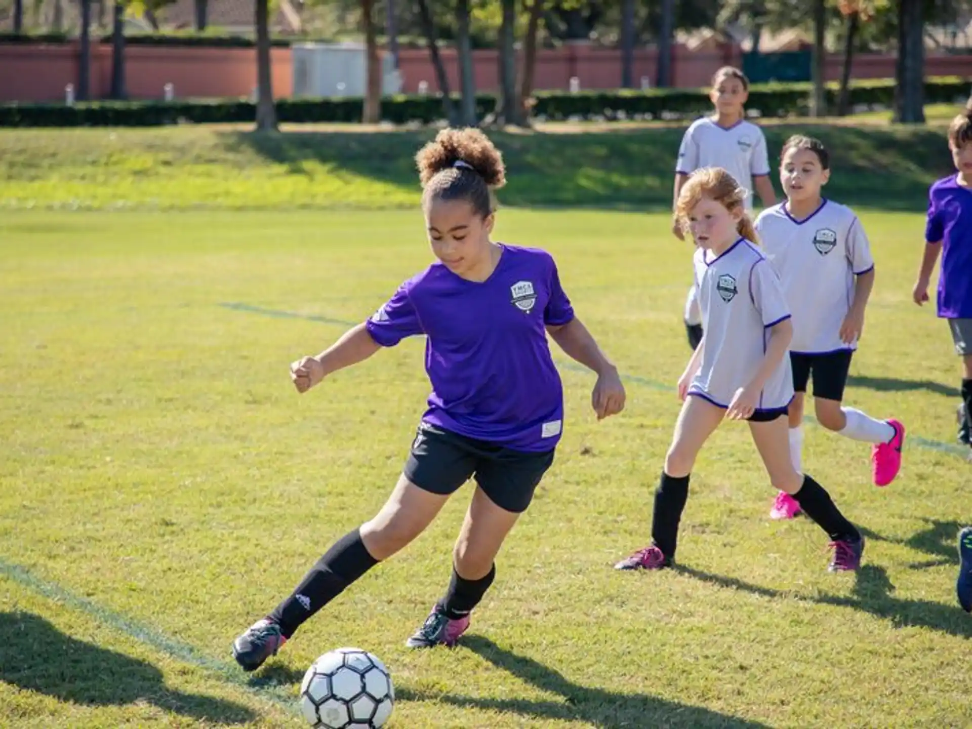 a group of girls compete over a football ball