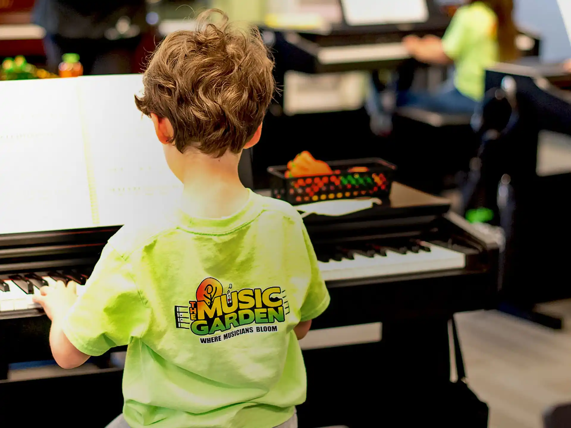 a boy playing a piano