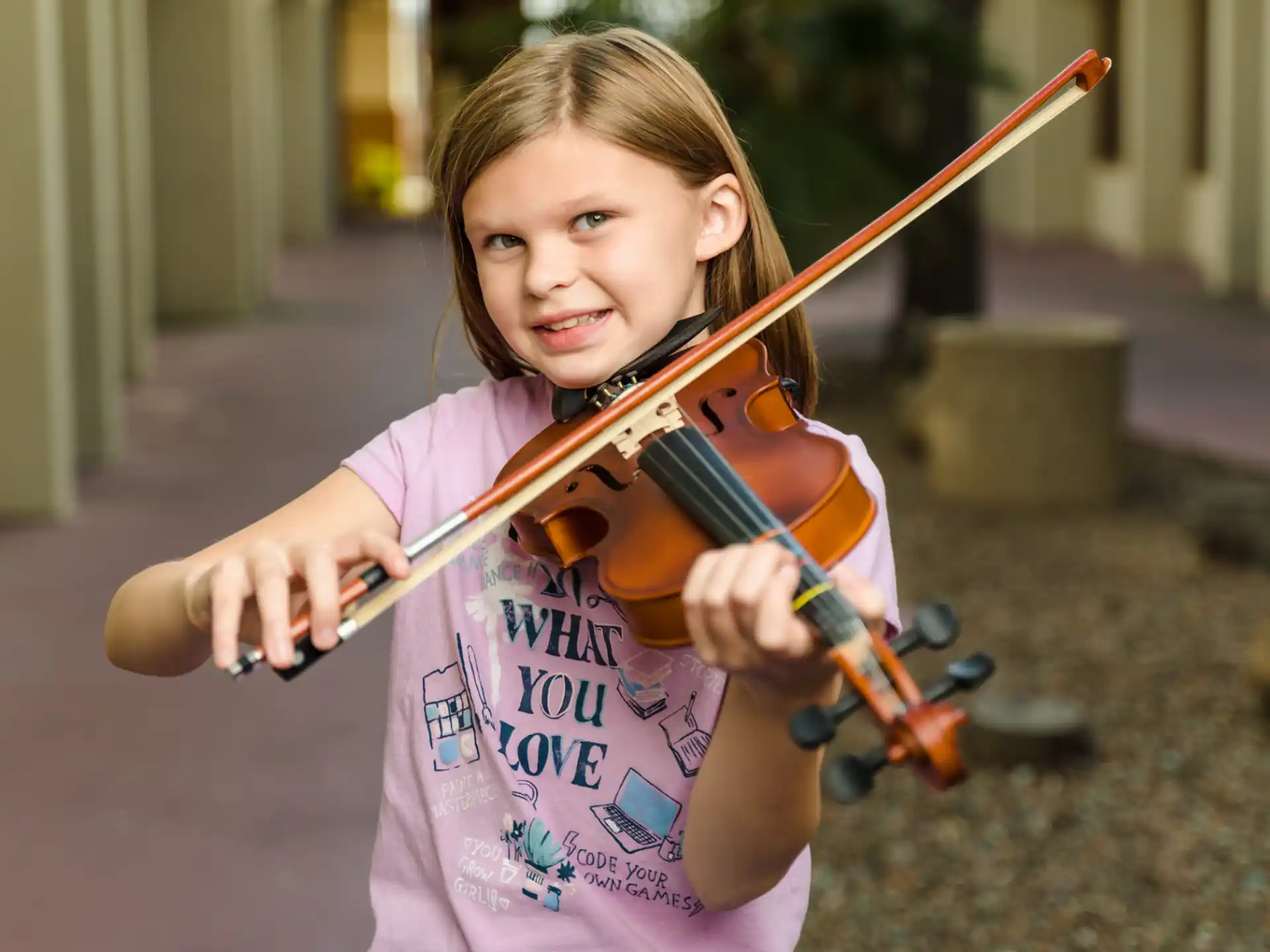 a young girl playing a violin
