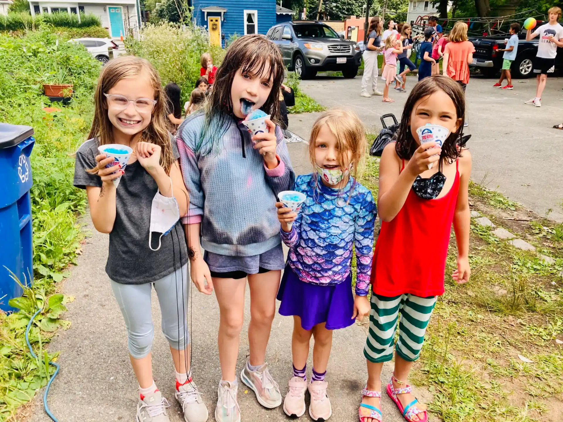 a group of girls holding objects posing for the camera