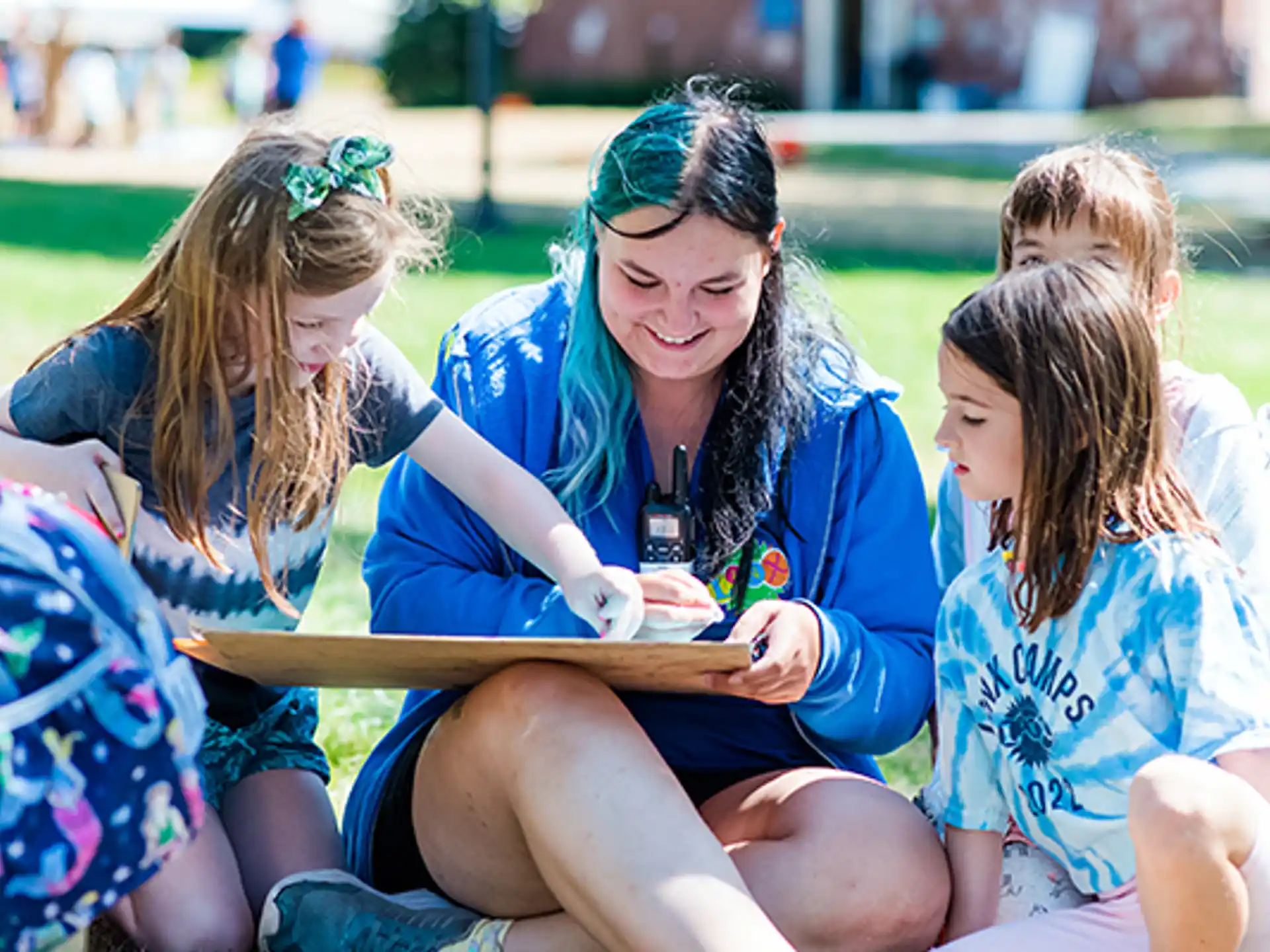 a group of girls sitting on the ground