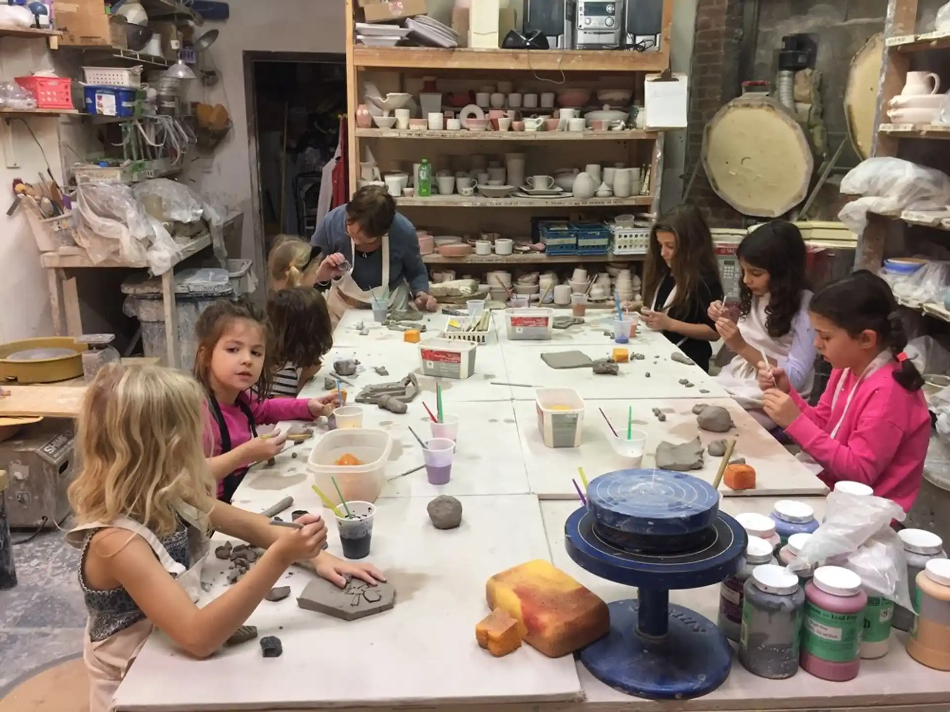 a group of children sitting around a table