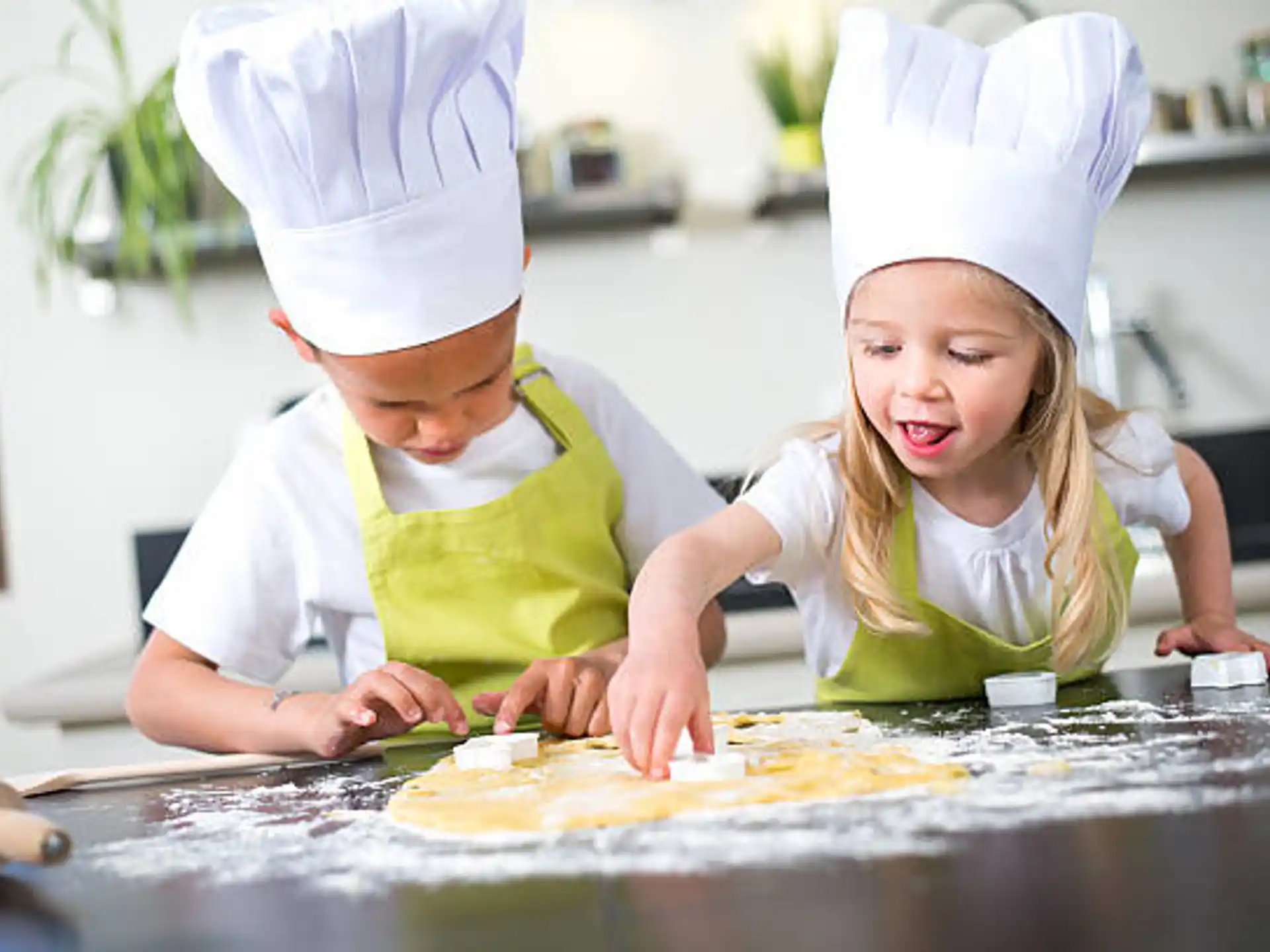 a couple of kids wearing chef hats