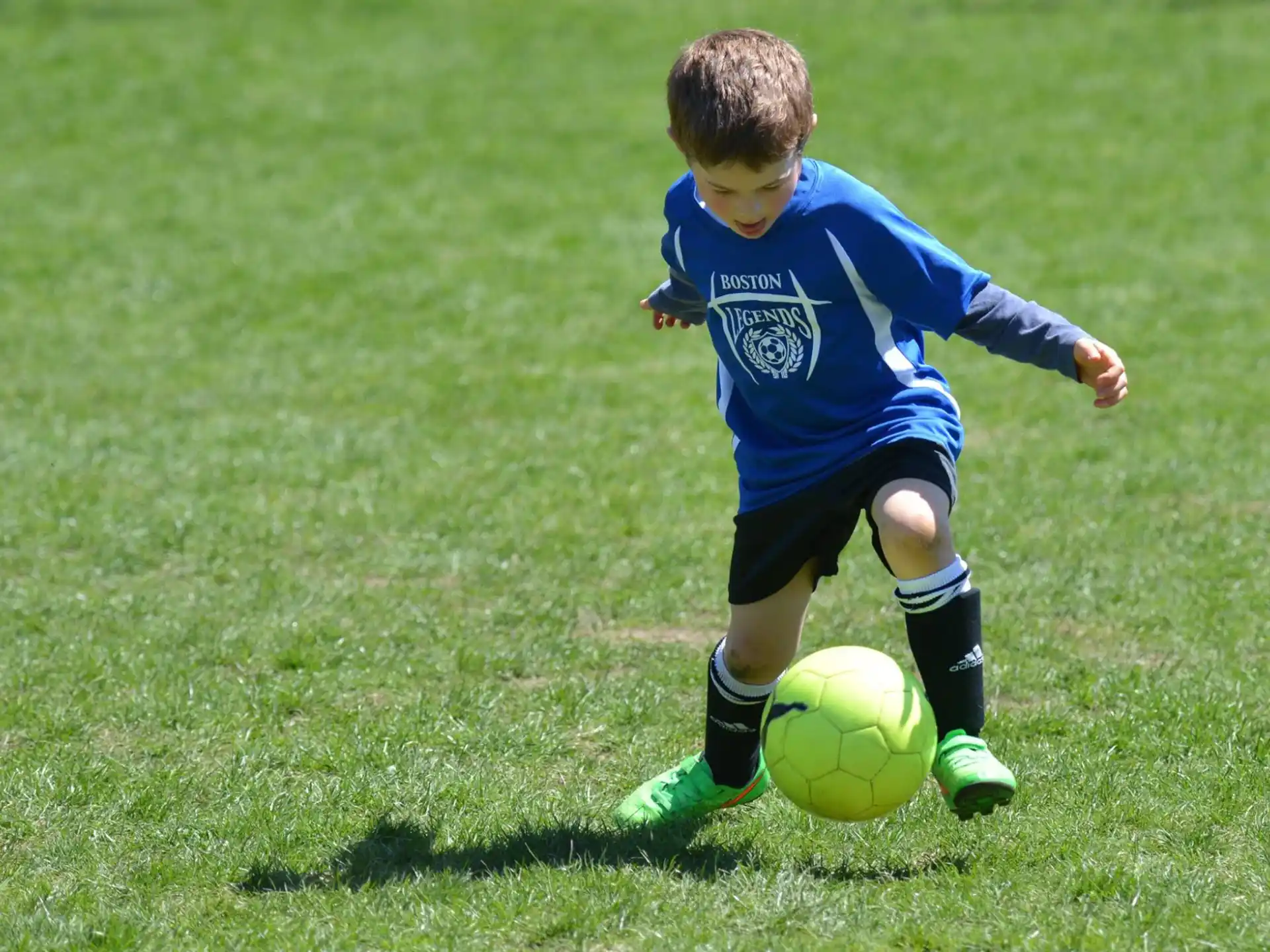a young boy playing football