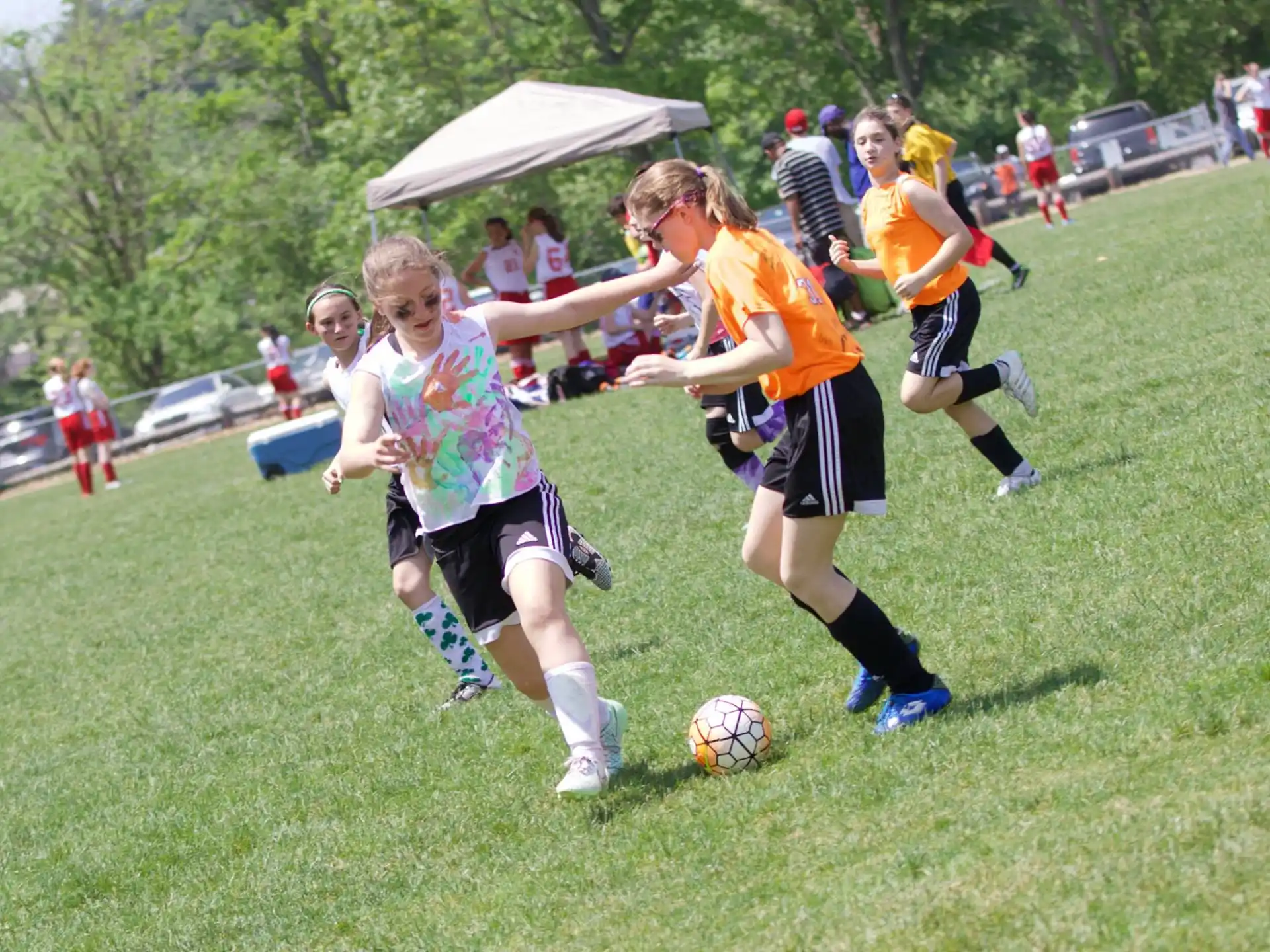 girls playing football on a field