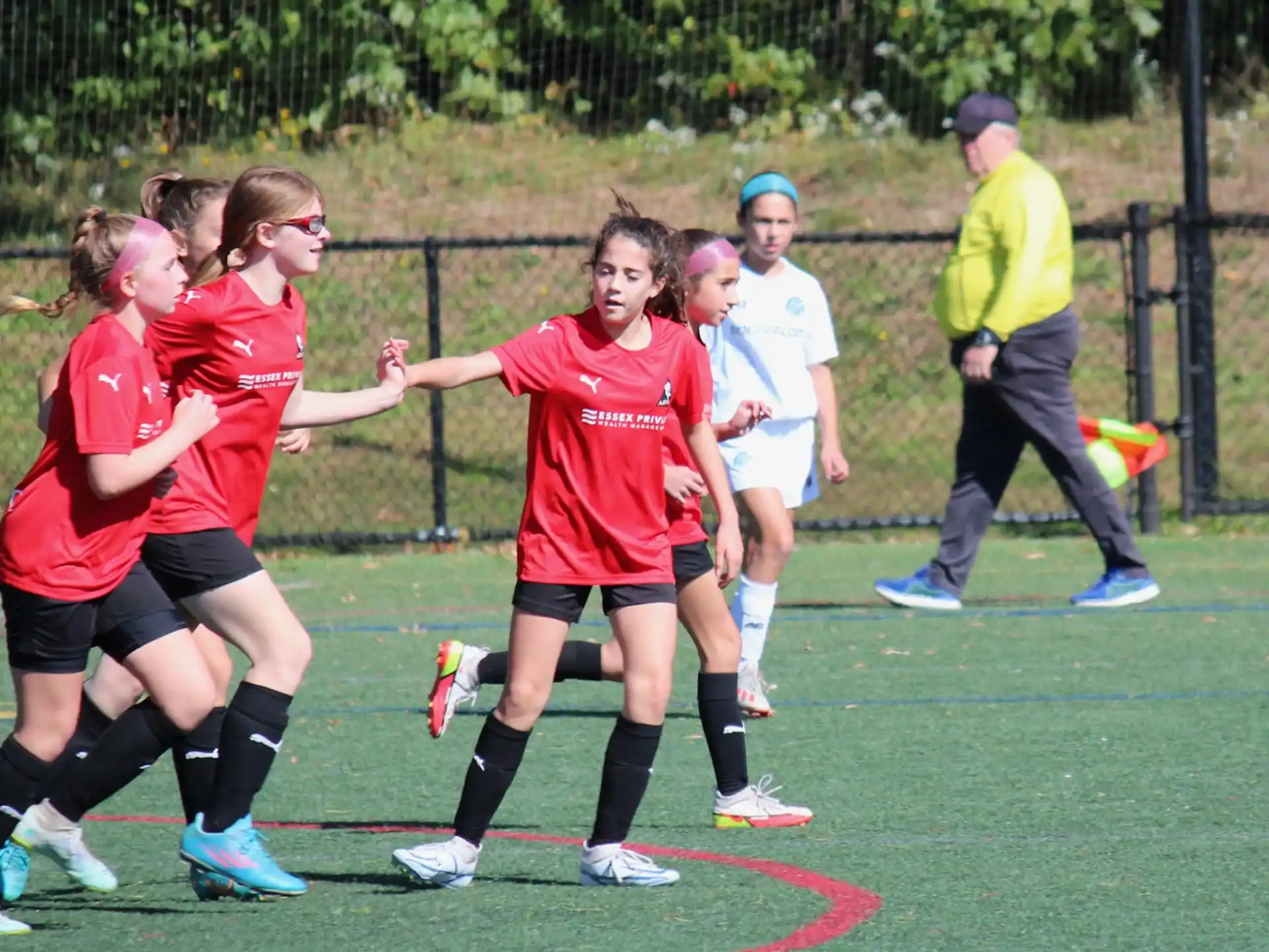 a group of girls running on a field