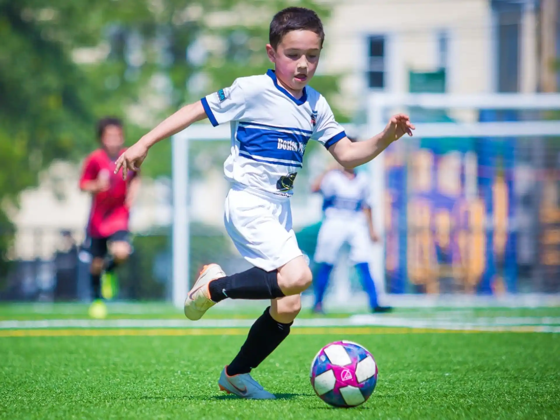 a boy kicking a football ball