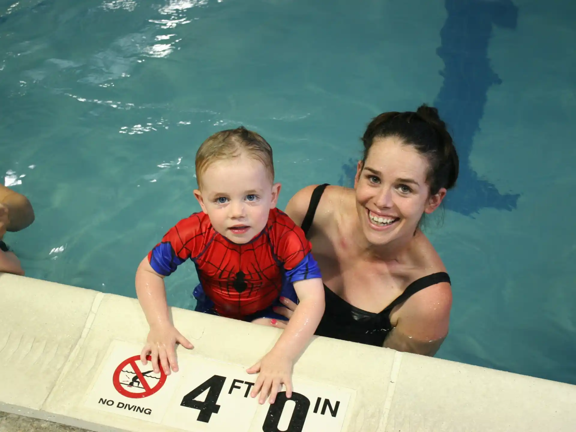 a person and a child in a pool