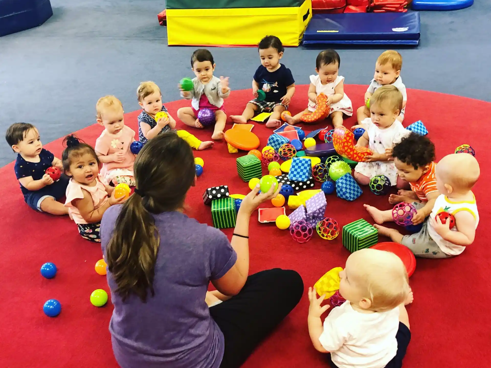 a person and several children sitting on the floor