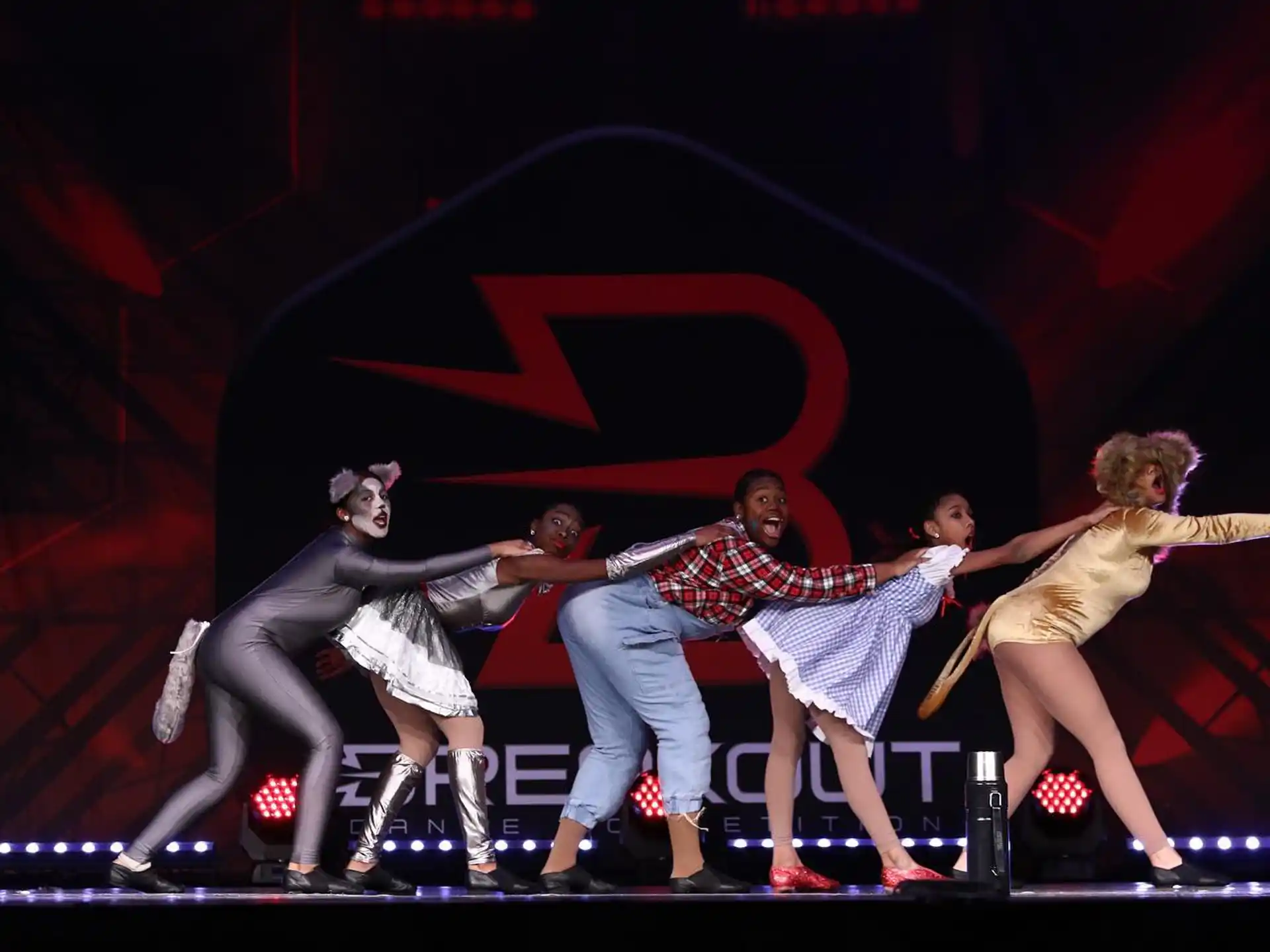 a group of people dancing on a stage